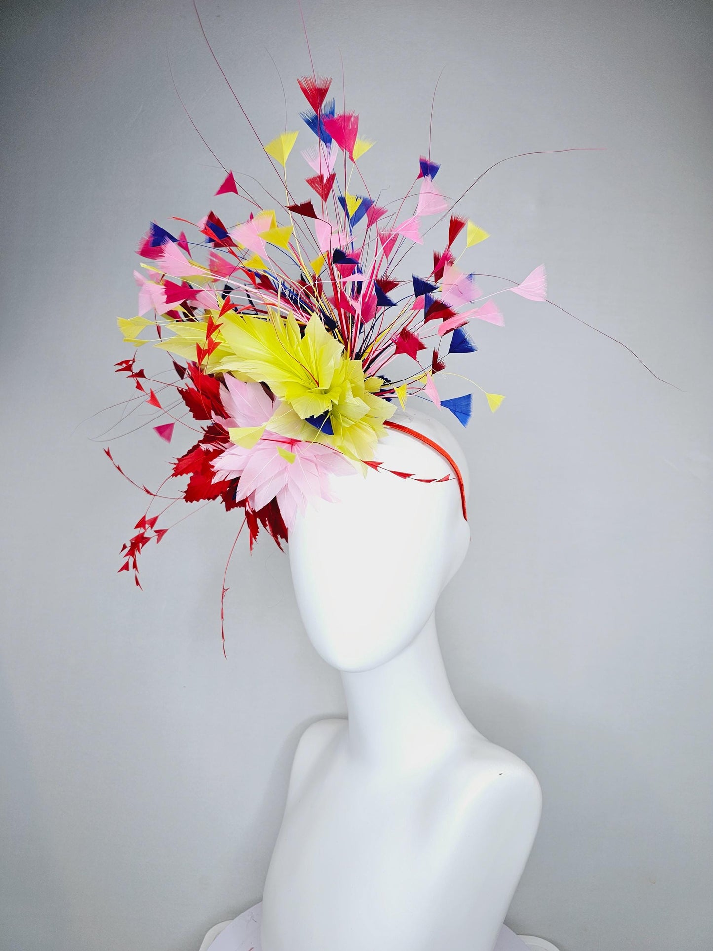 kentucky derby hat fascinator light pink and red zigzag feather flowers with colorful light pink, yellow, cobalt blue,red branching feathers
