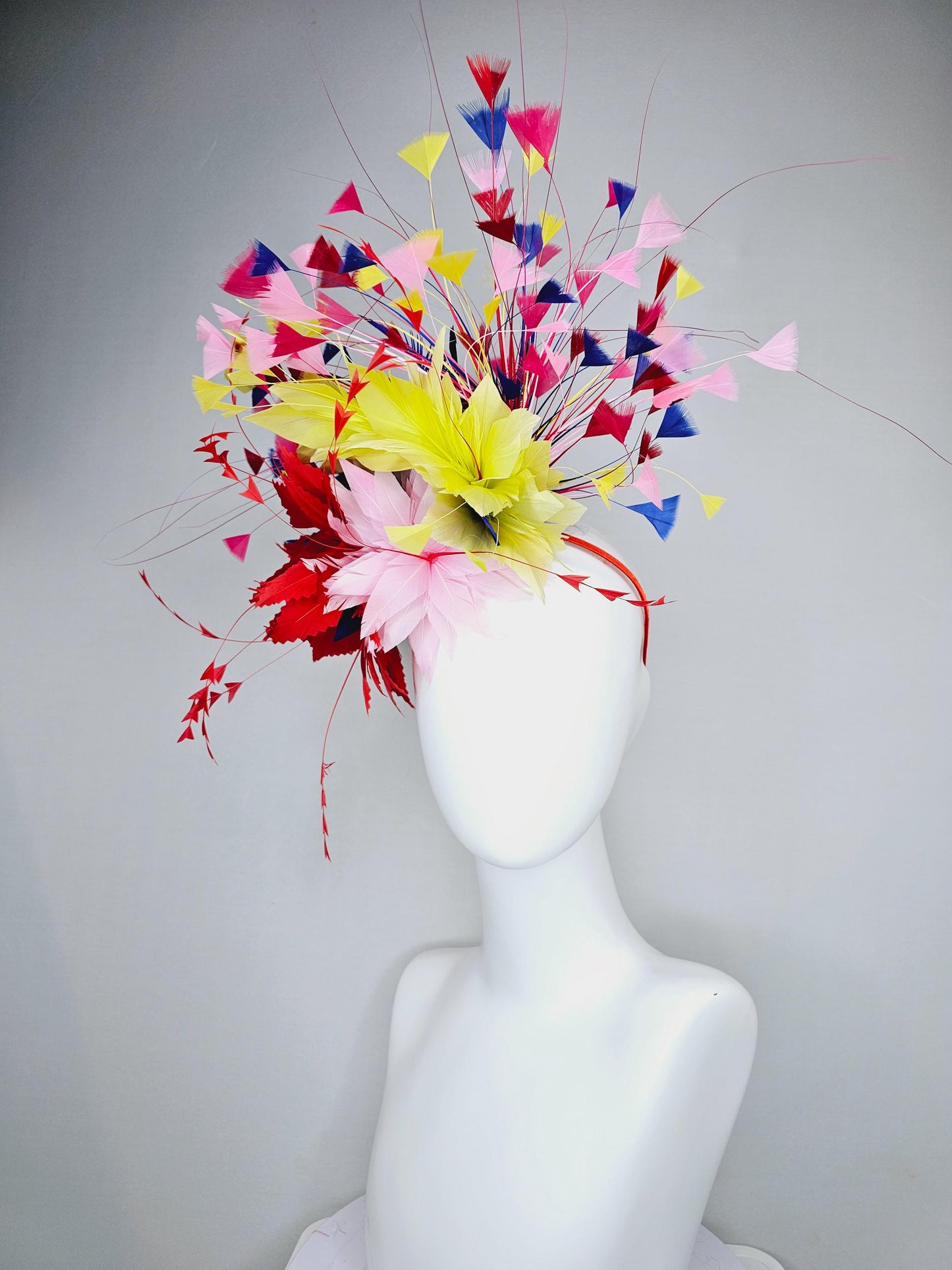 kentucky derby hat fascinator light pink and red zigzag feather flowers with colorful light pink, yellow, cobalt blue,red branching feathers