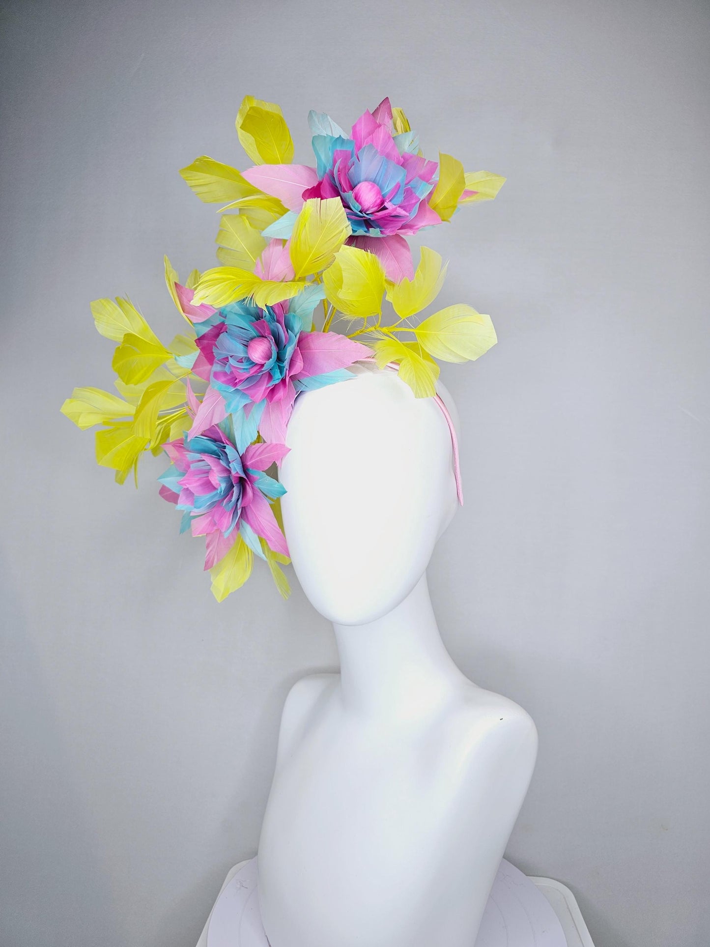 kentucky derby hat fascinator with large blush pink and baby sky blue feather flowers and yellow branching feathers