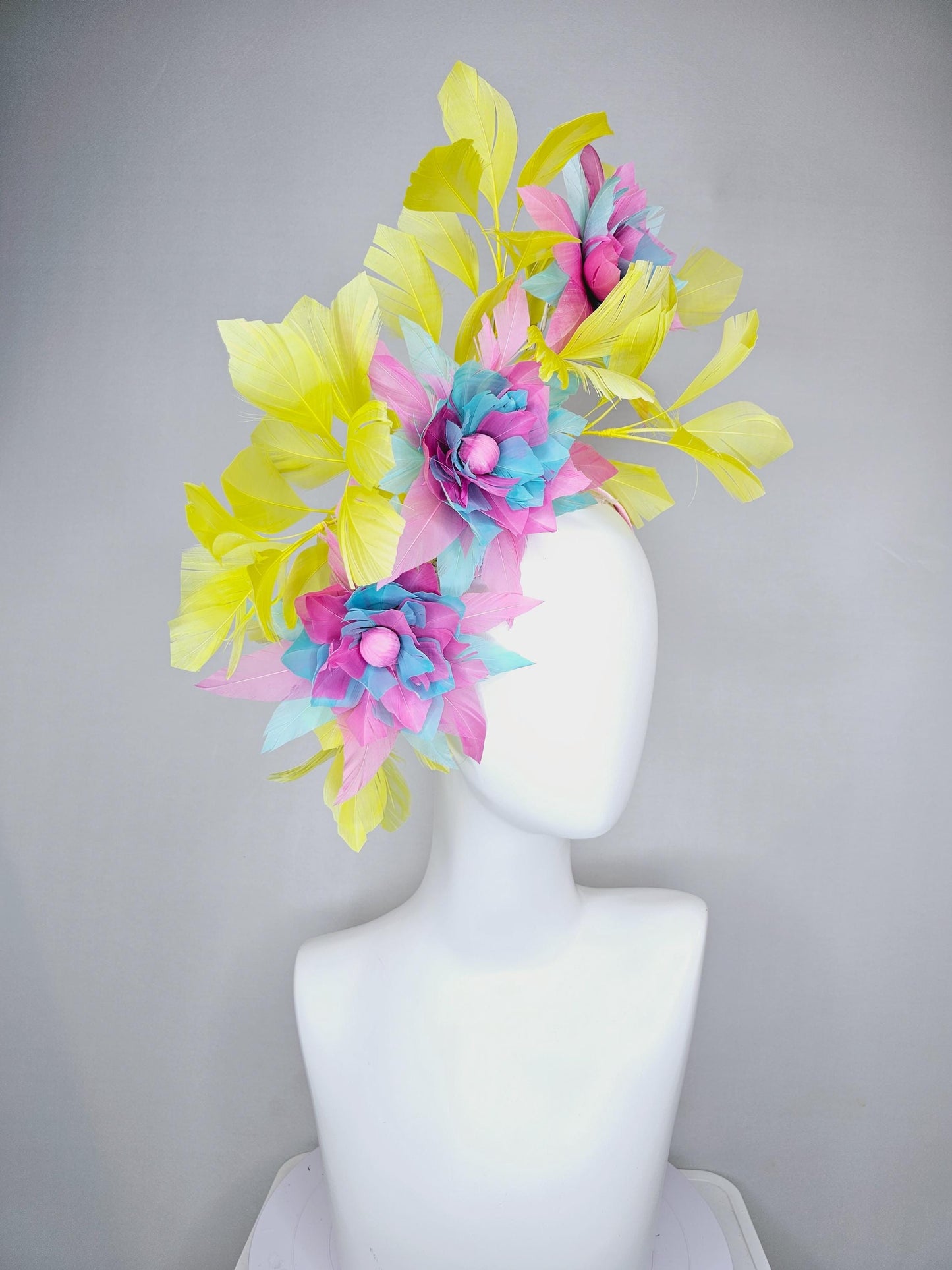 kentucky derby hat fascinator with large blush pink and baby sky blue feather flowers and yellow branching feathers