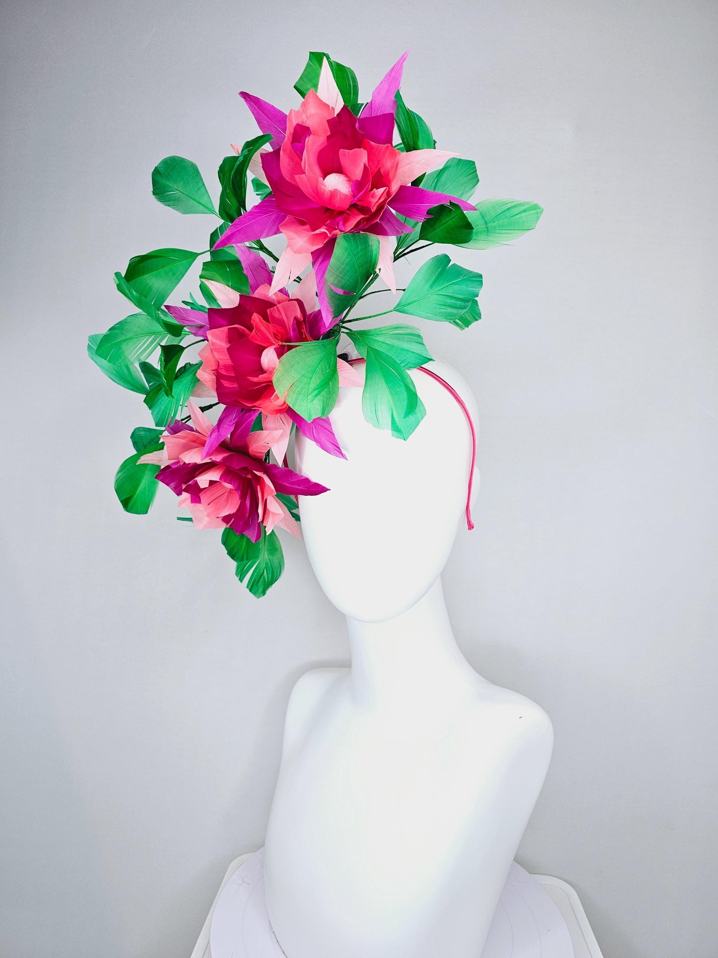 kentucky derby hat fascinator with large burgundy red raspberry red fuchsia pink feather flowers and emerald green branching feathers