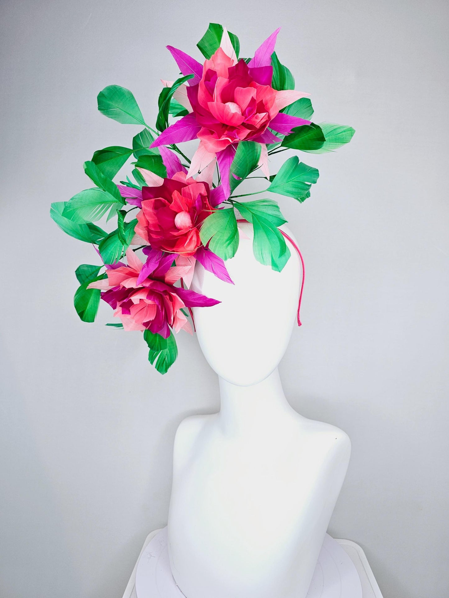 kentucky derby hat fascinator with large burgundy red raspberry red fuchsia pink feather flowers and emerald green branching feathers