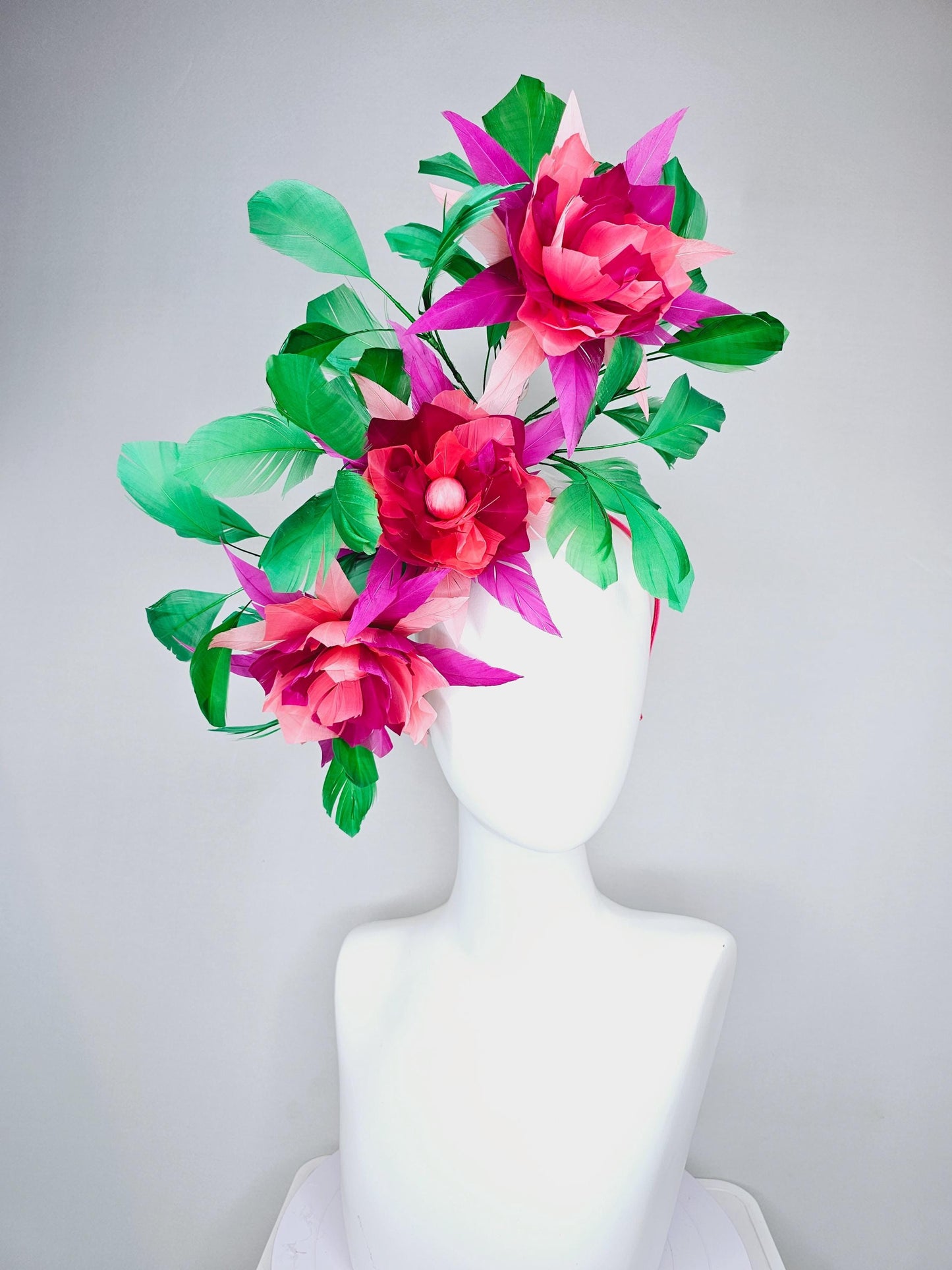 kentucky derby hat fascinator with large burgundy red raspberry red fuchsia pink feather flowers and emerald green branching feathers