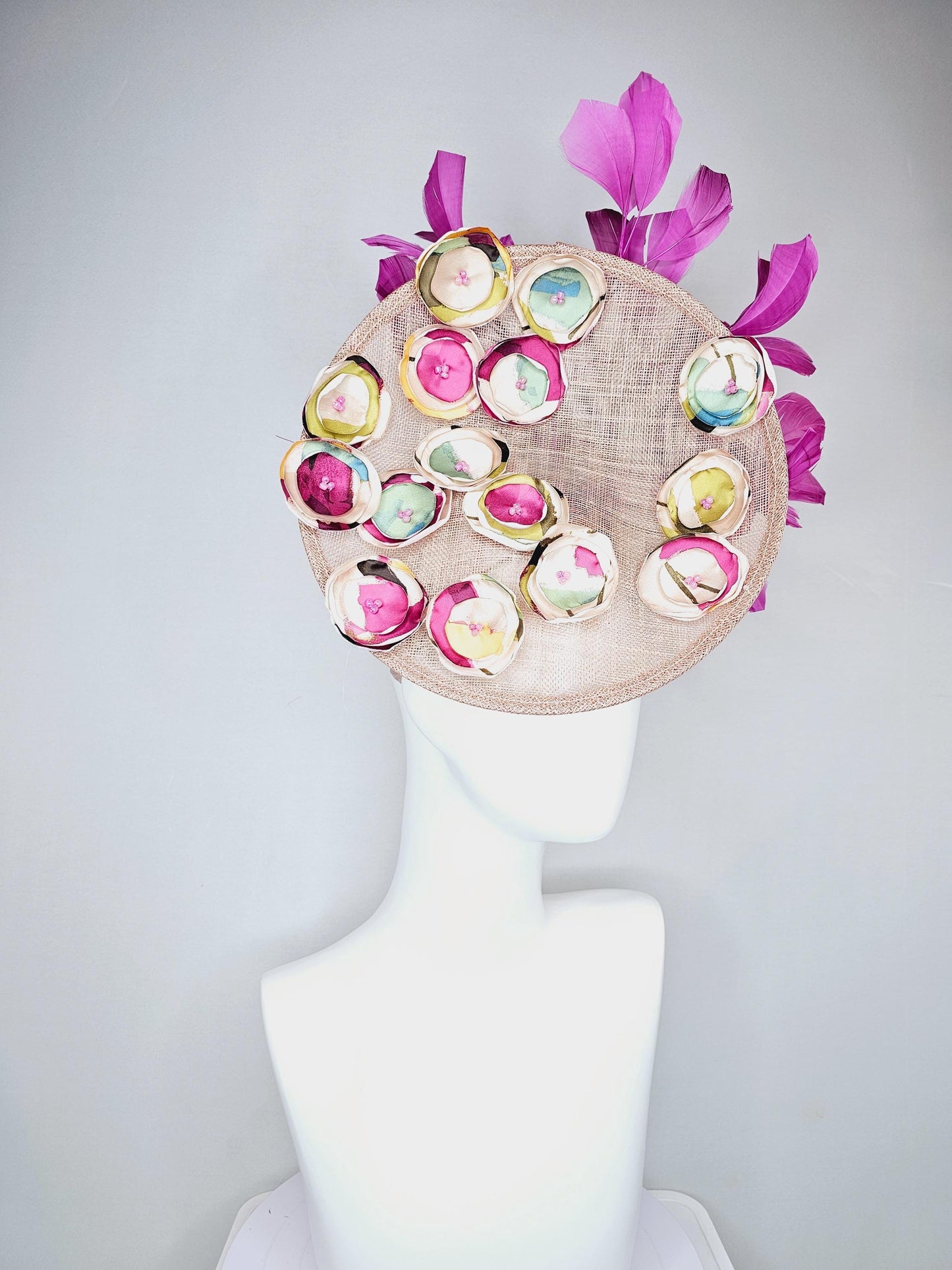 kentucky derby hat fascinator dusty pink champagne sinamay saucer with burgundy red yellow blue green satin flowers, magenta pink feathers