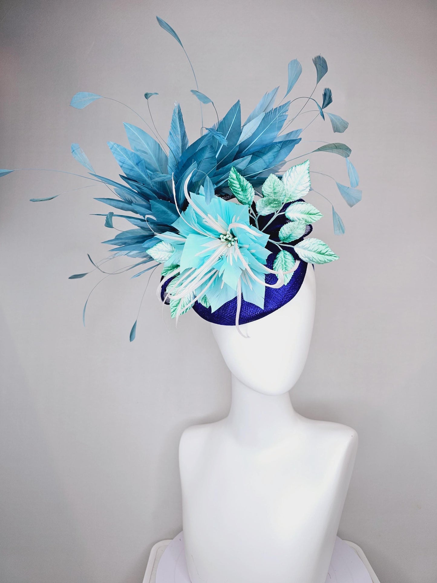 kentucky derby hat fascinator royal cobalt blue sinamay with sky blue feather flower, green velvet leaves, teal blue branching feathers