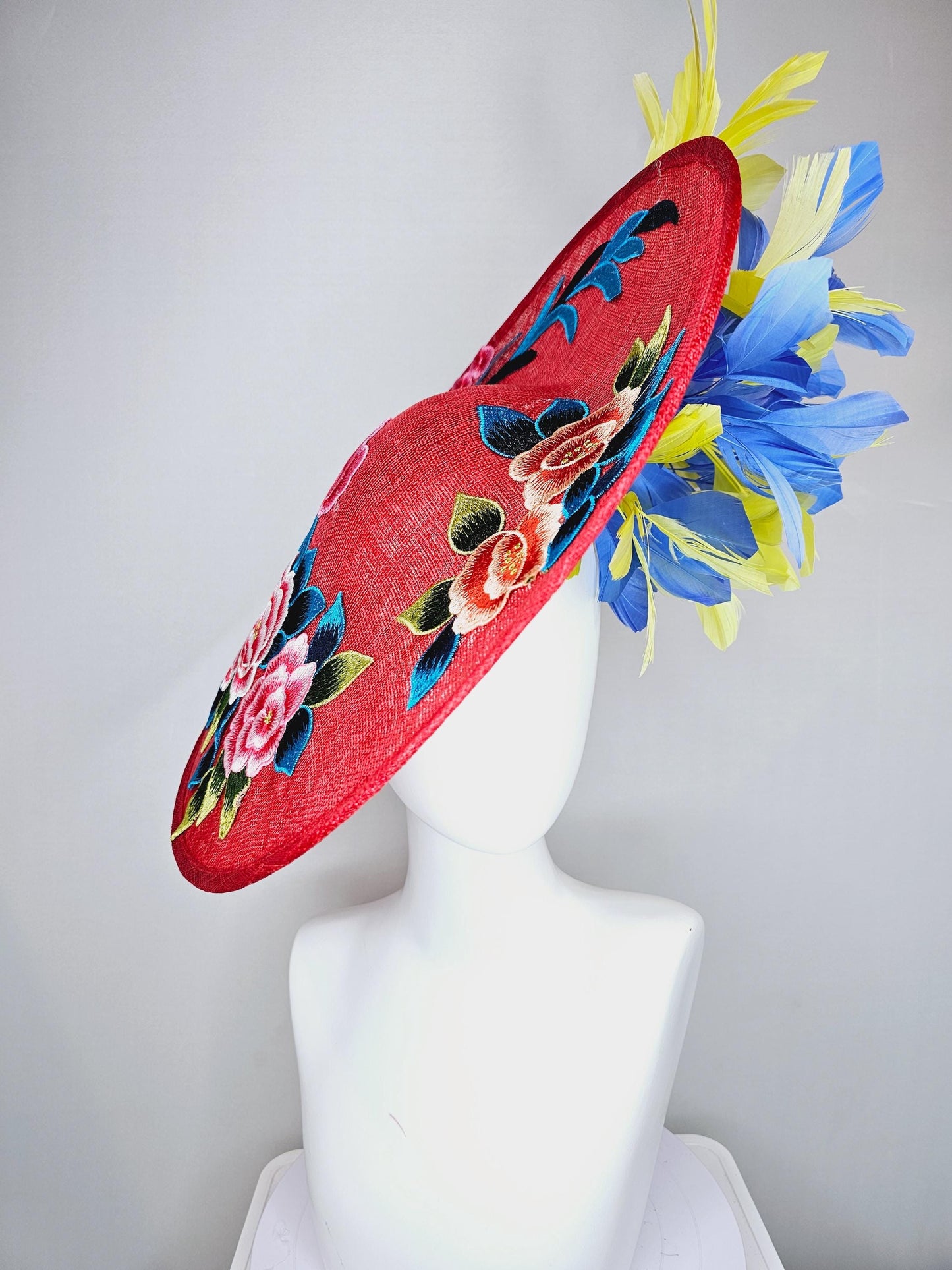 kentucky derby hat fascinator large red sinamay saucer with pink orange blue green embroidered flowers, cobalt blue and yellow feathers