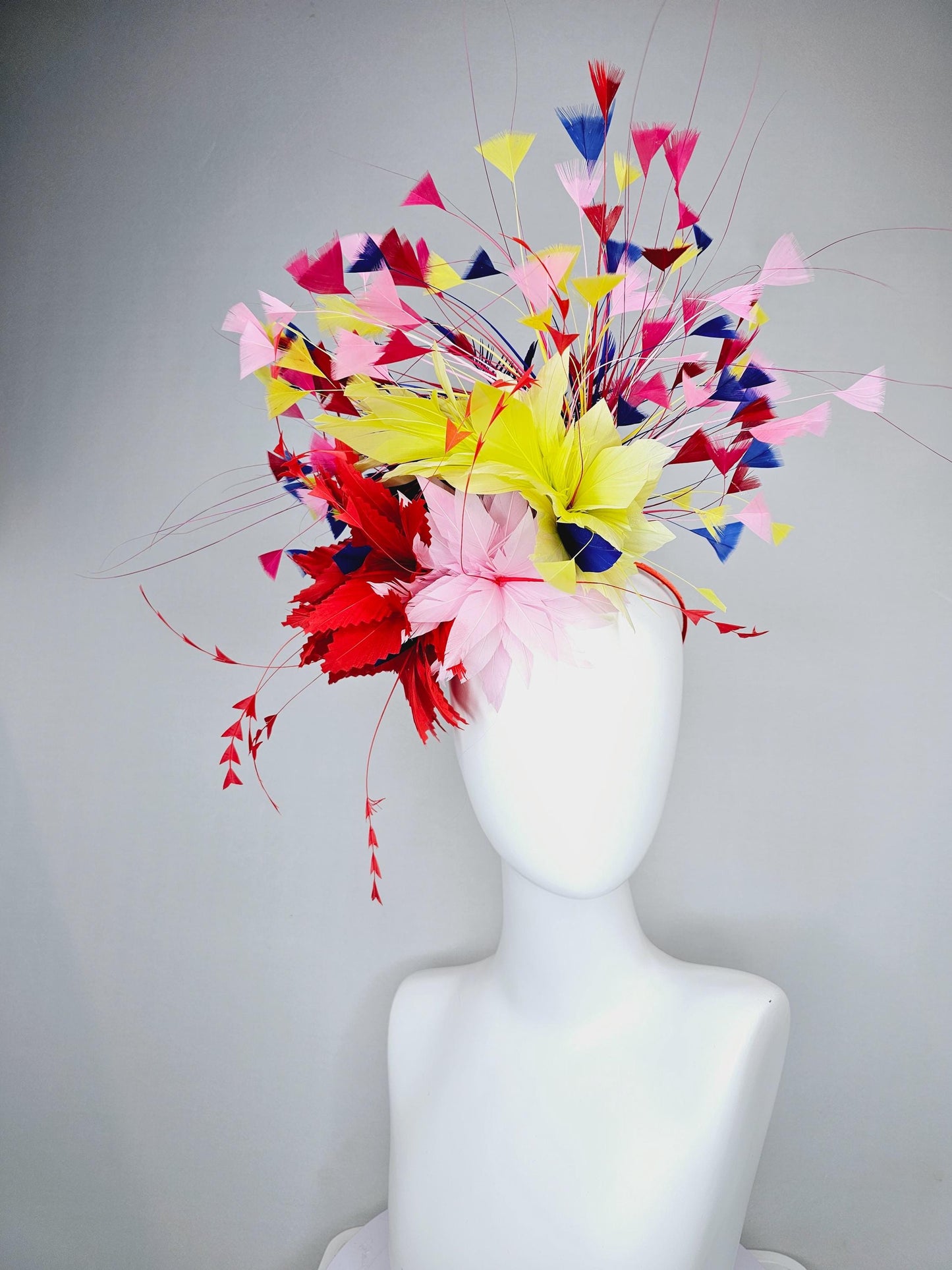 kentucky derby hat fascinator light pink and red zigzag feather flowers with colorful light pink, yellow, cobalt blue,red branching feathers