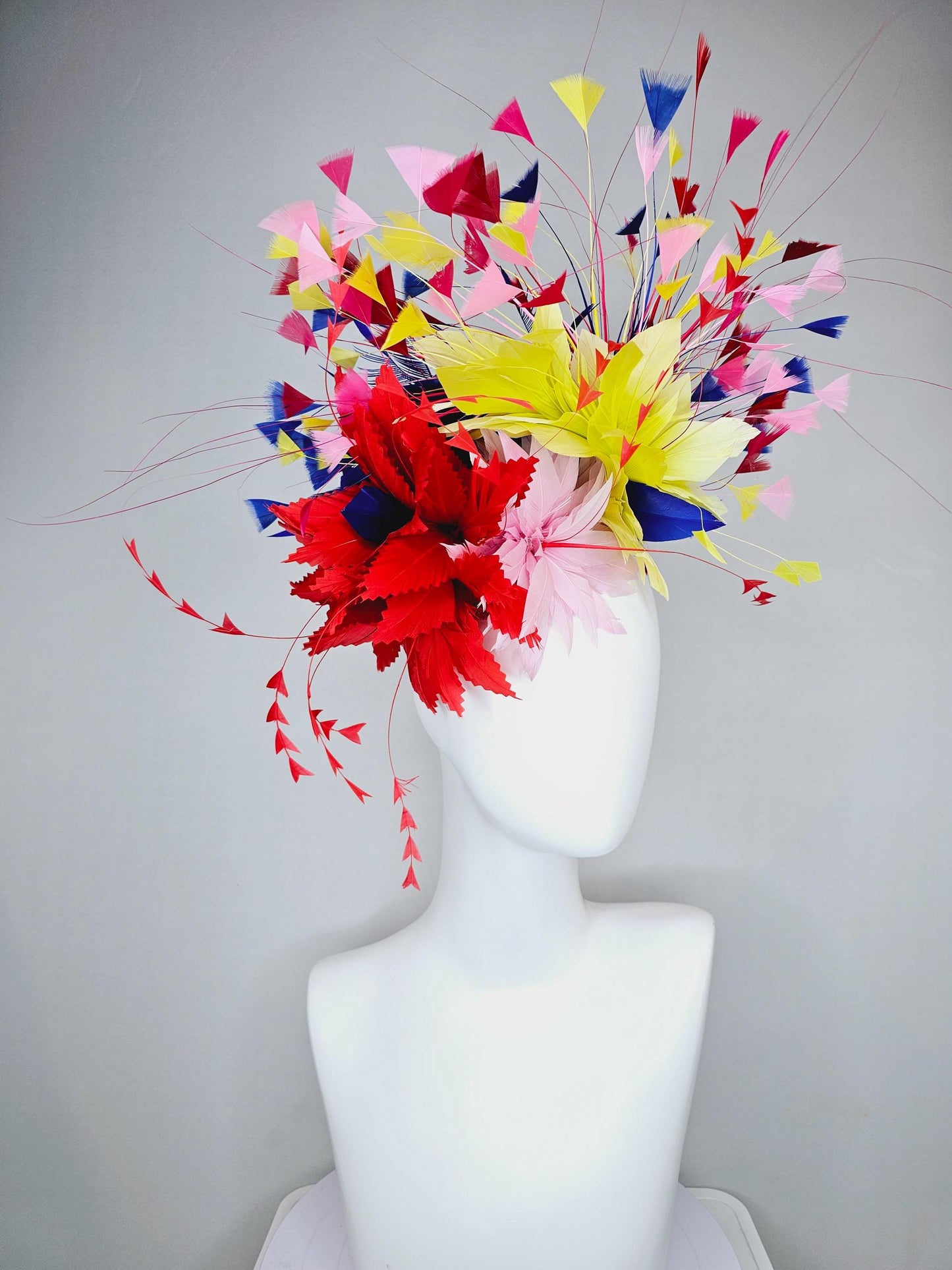 kentucky derby hat fascinator light pink and red zigzag feather flowers with colorful light pink, yellow, cobalt blue,red branching feathers