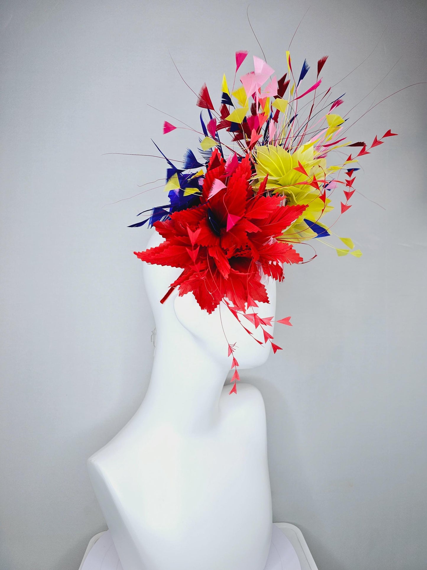 kentucky derby hat fascinator light pink and red zigzag feather flowers with colorful light pink, yellow, cobalt blue,red branching feathers