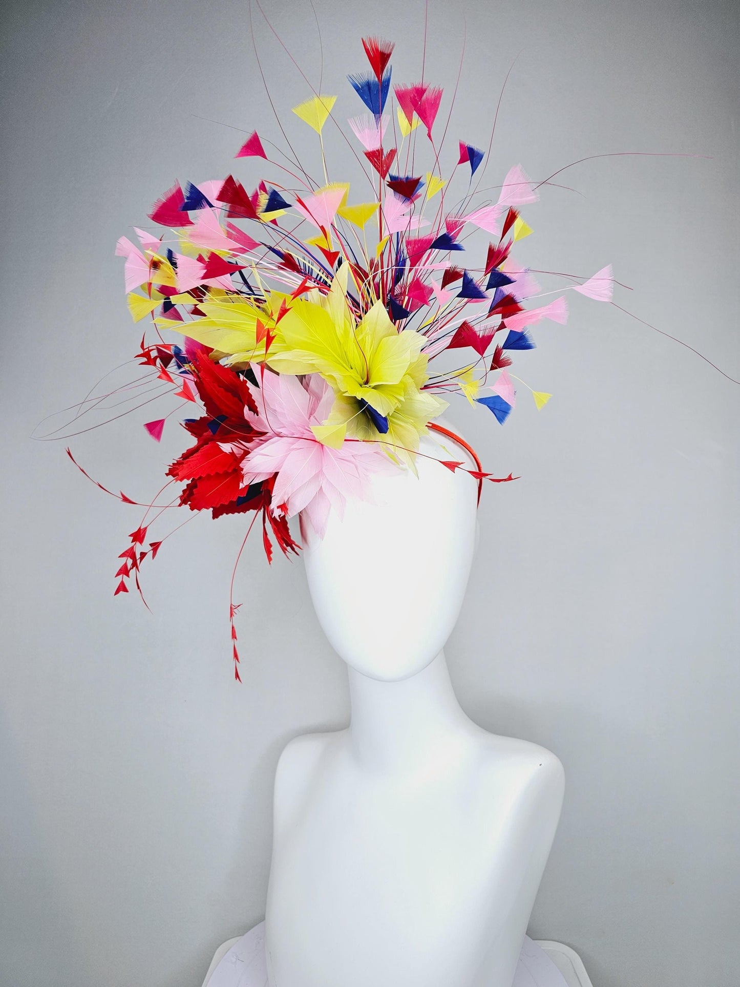 kentucky derby hat fascinator light pink and red zigzag feather flowers with colorful light pink, yellow, cobalt blue,red branching feathers