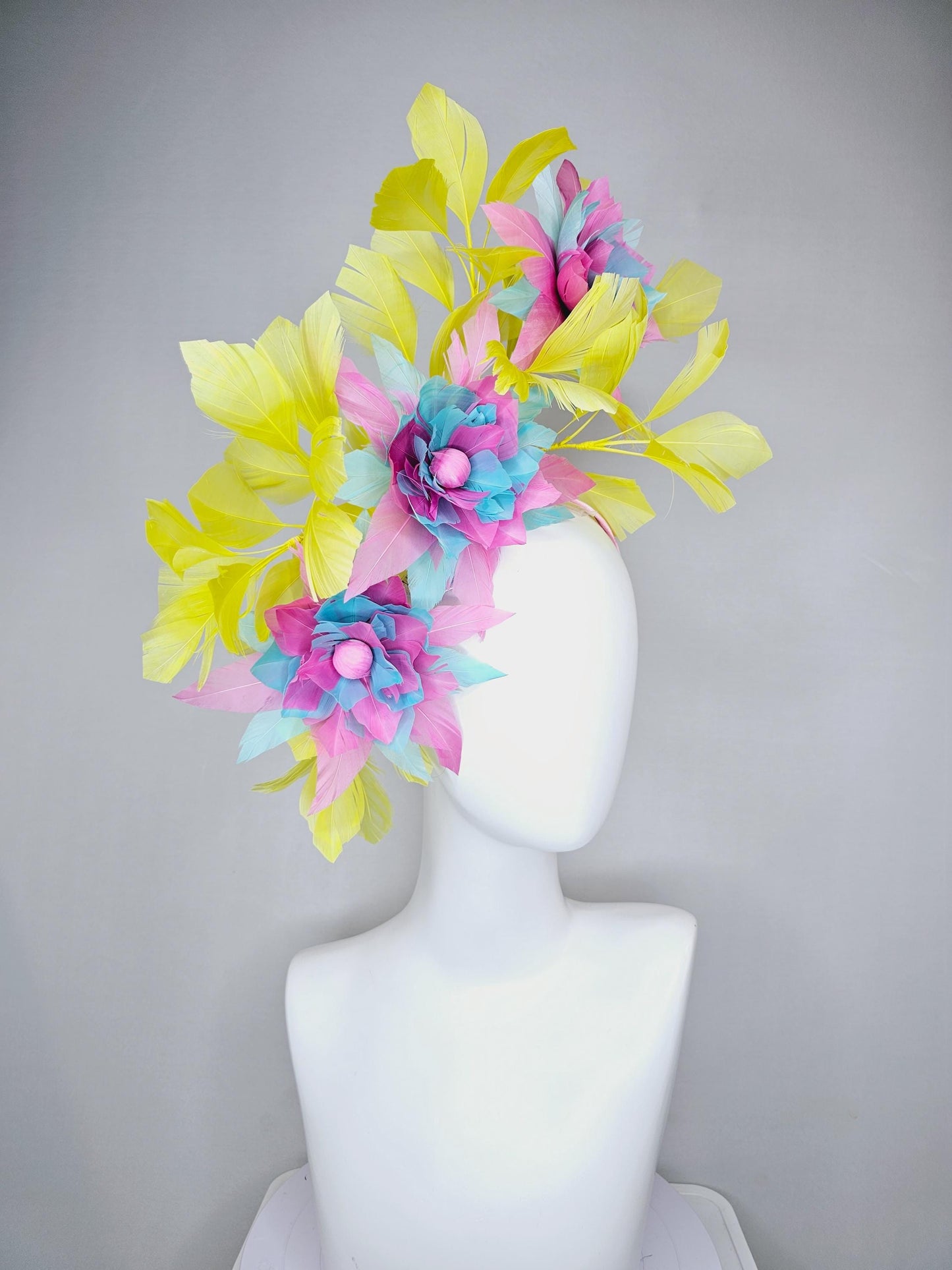 kentucky derby hat fascinator with large blush pink and baby sky blue feather flowers and yellow branching feathers