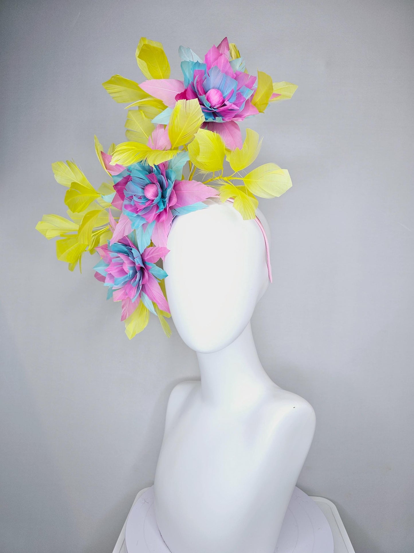 kentucky derby hat fascinator with large blush pink and baby sky blue feather flowers and yellow branching feathers
