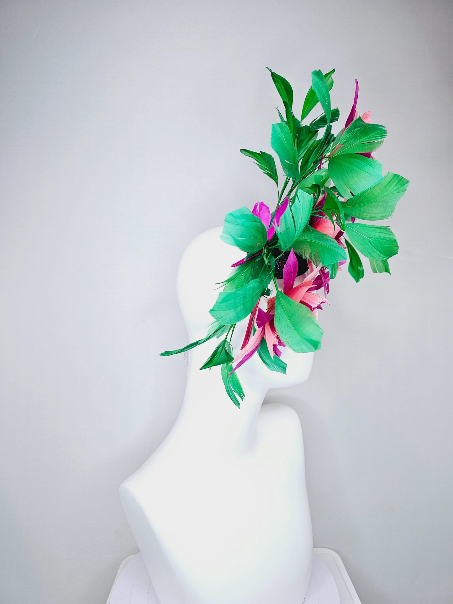 kentucky derby hat fascinator with large burgundy red raspberry red fuchsia pink feather flowers and emerald green branching feathers