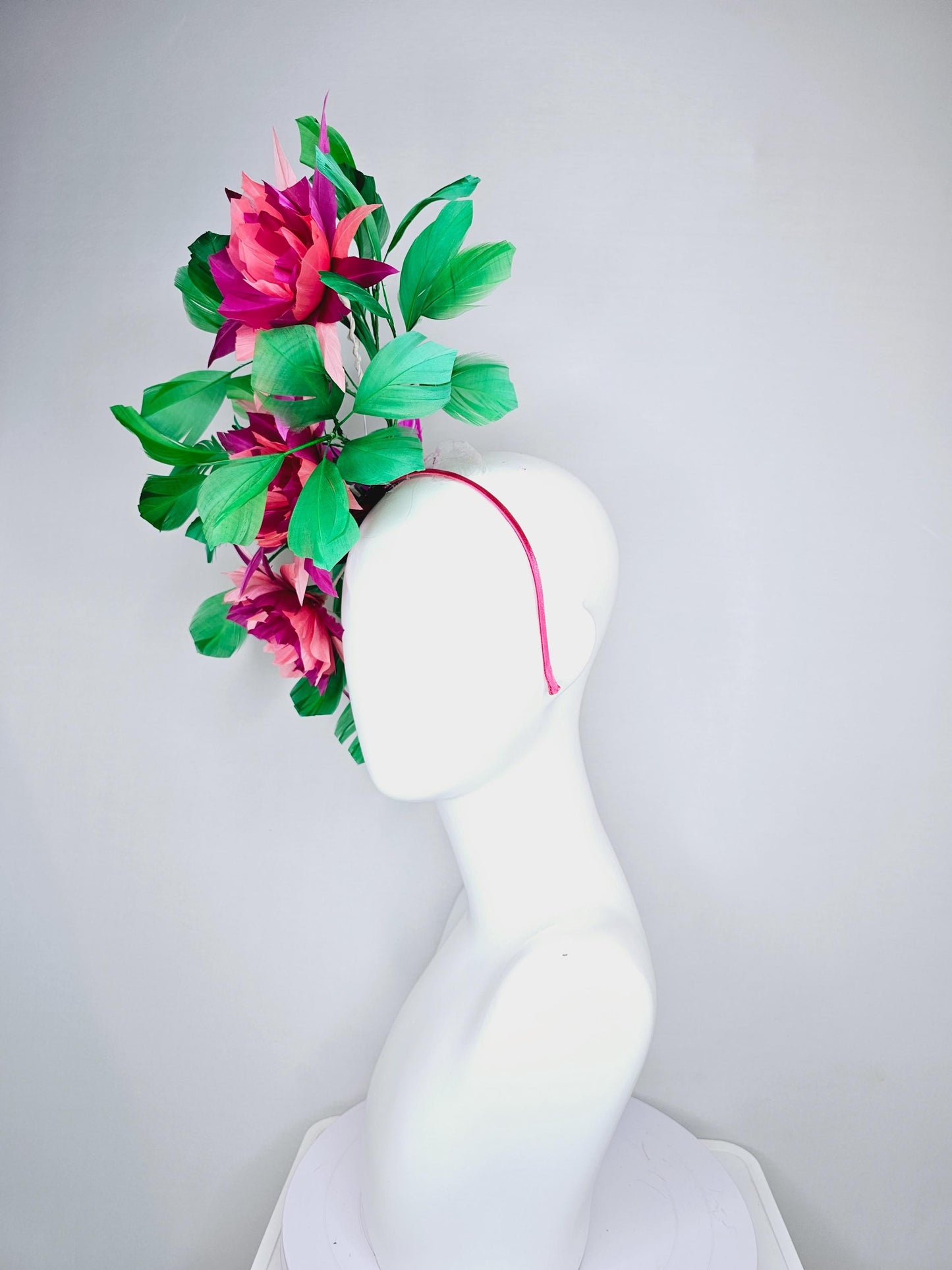 kentucky derby hat fascinator with large burgundy red raspberry red fuchsia pink feather flowers and emerald green branching feathers