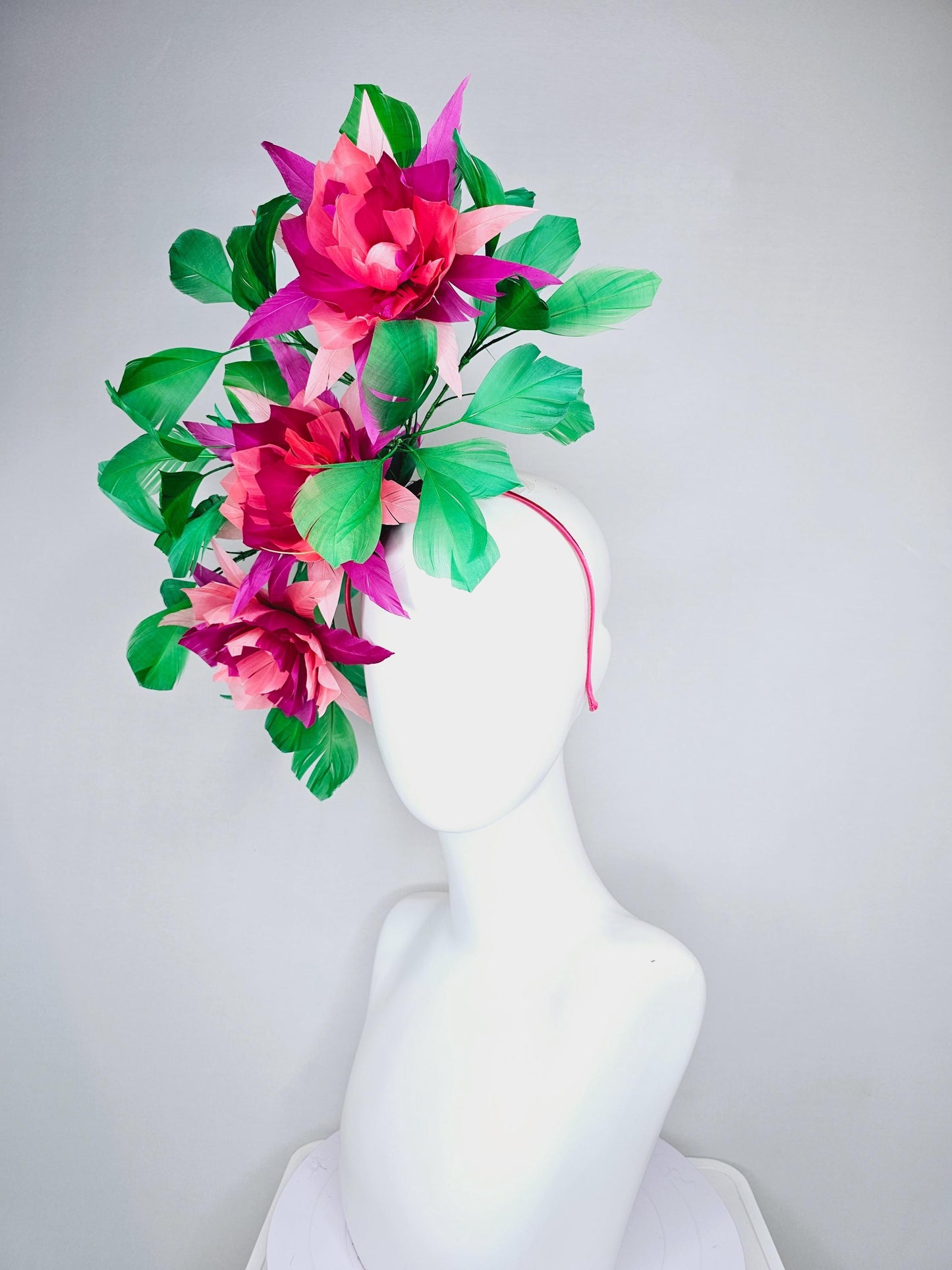 kentucky derby hat fascinator with large burgundy red raspberry red fuchsia pink feather flowers and emerald green branching feathers