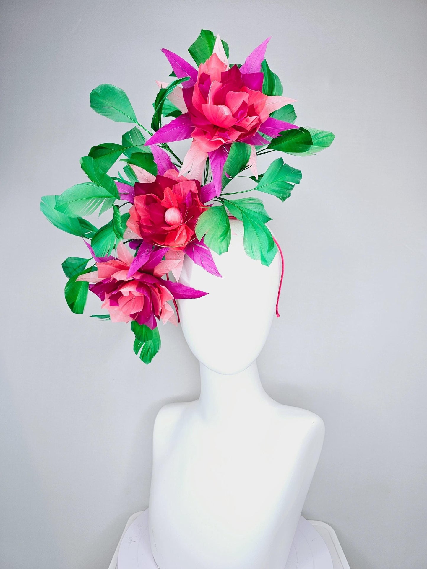kentucky derby hat fascinator with large burgundy red raspberry red fuchsia pink feather flowers and emerald green branching feathers