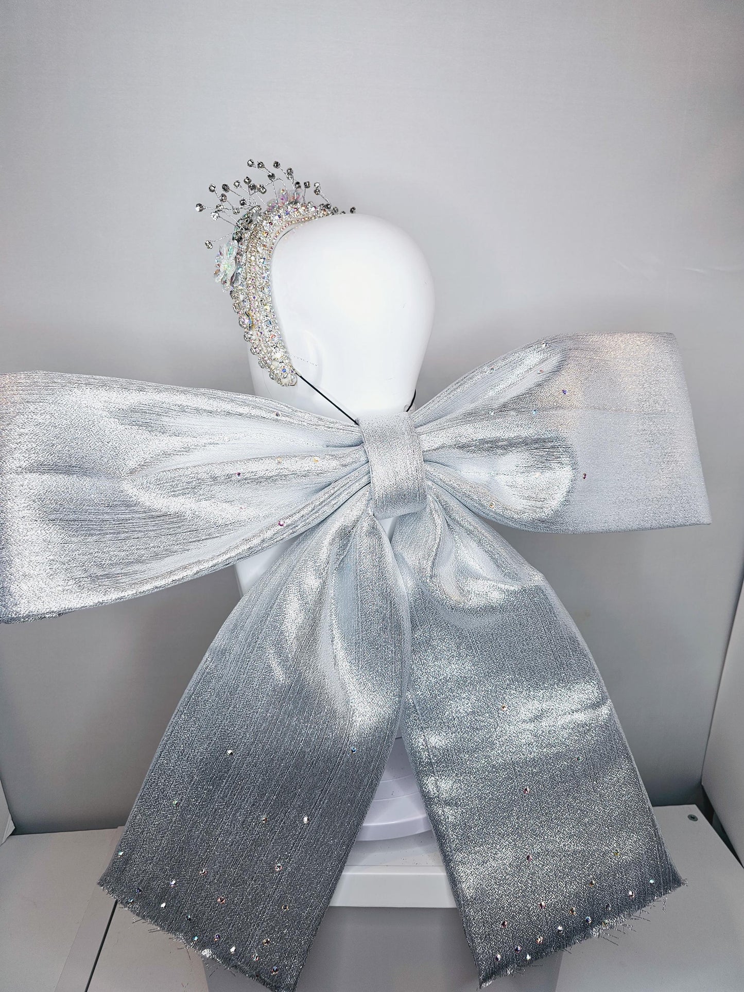 kentucky derby hat large thick crystal rhinestone tiara encrusted headband with huge silver padded ribbon bow decor along back with crystals