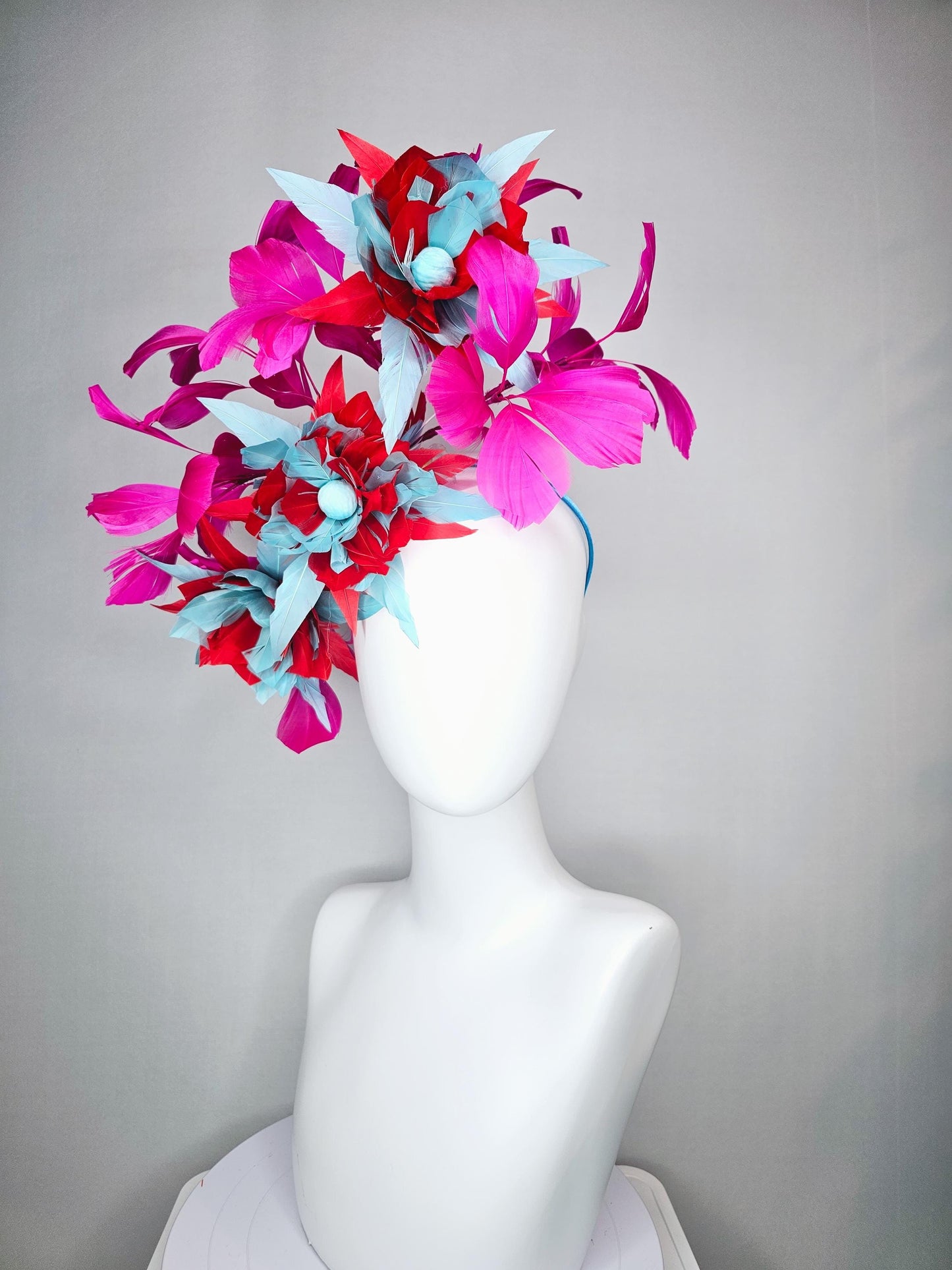 kentucky derby hat fascinator with large scarlet red and baby blue feather flowers and bright pink branching feathers