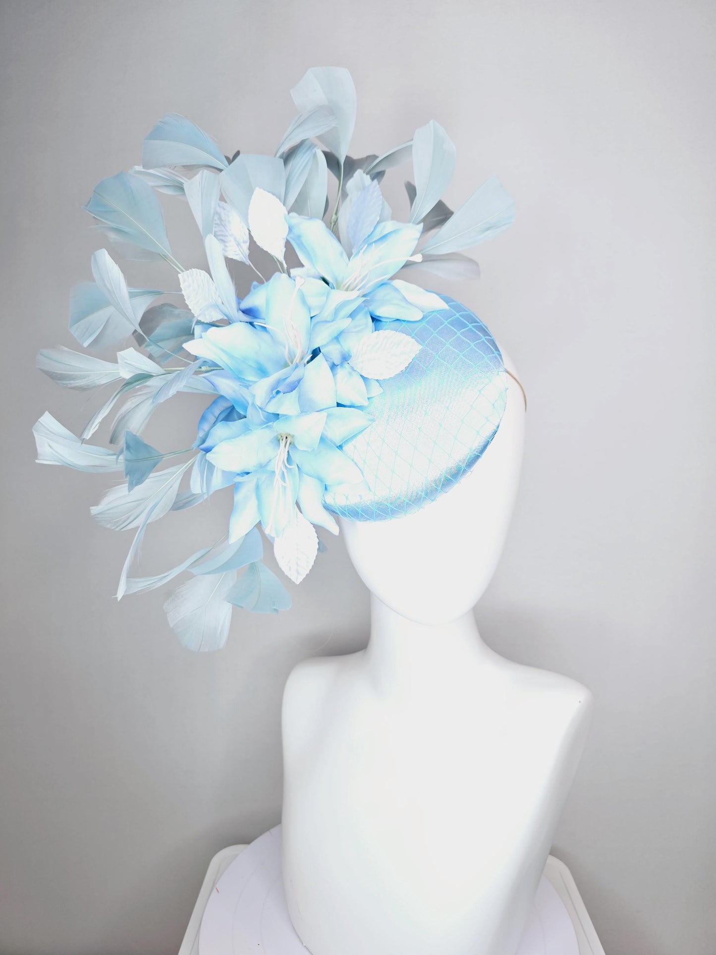 kentucky derby hat fascinator baby blue satin with netting light blue ombre satin flowers and leaves and light baby blue branching feathers