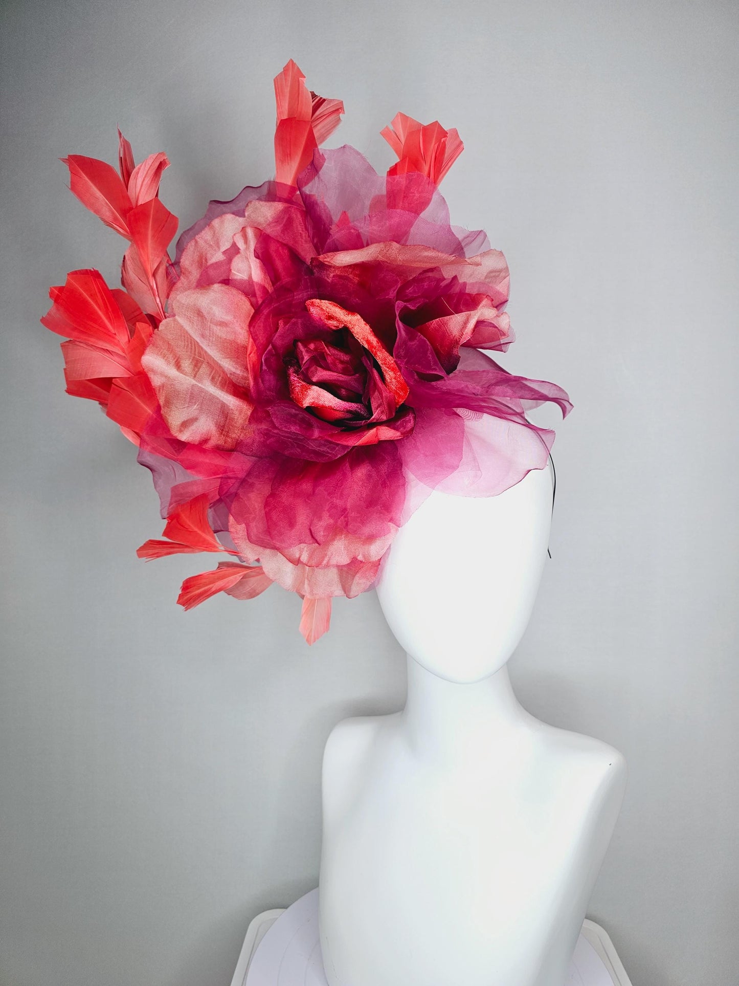 kentucky derby fascinator black headband with very large burgundy wine coral red organza flower and coral red branching feathers