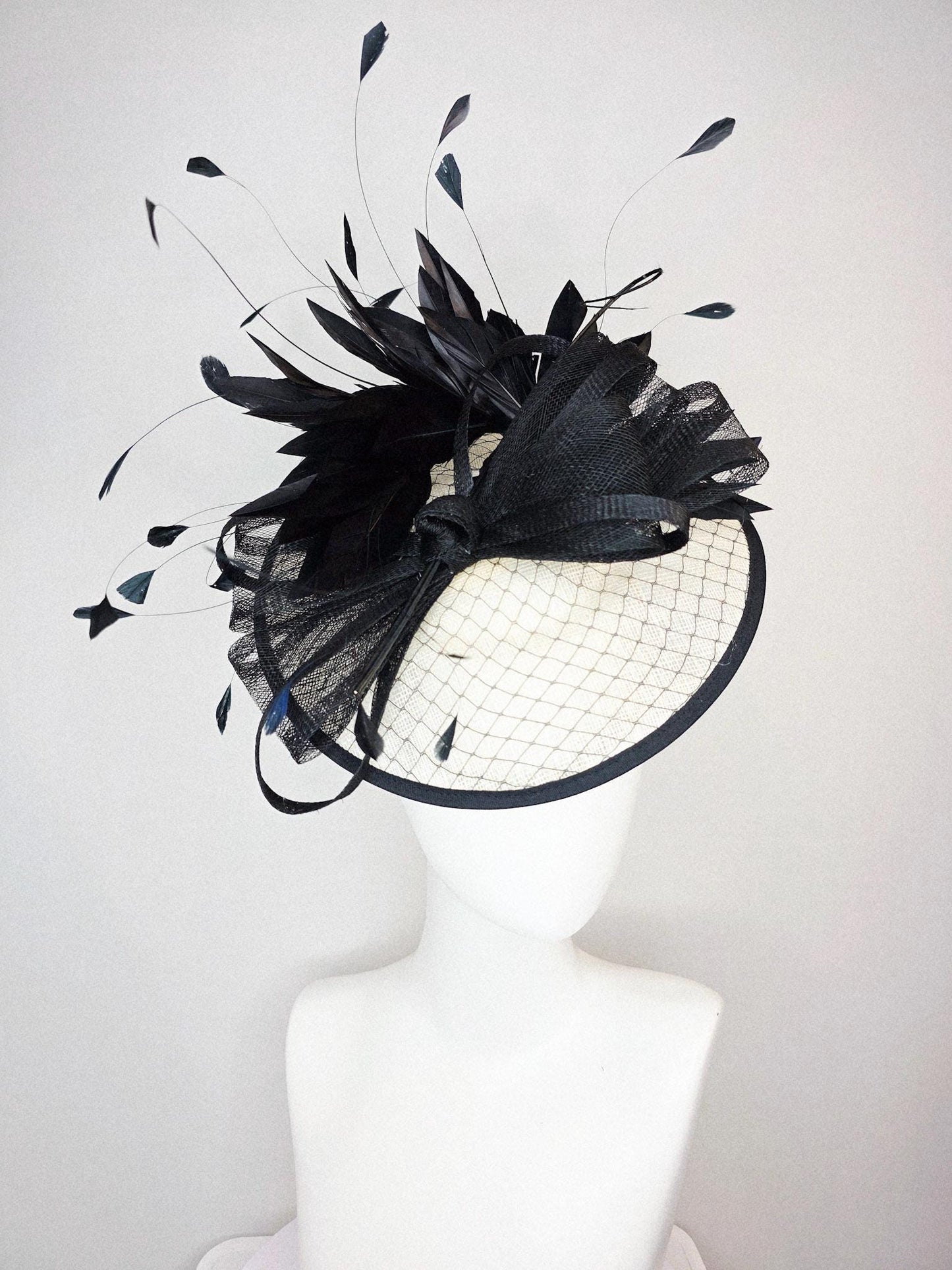 kentucky derby hat fascinator ivory white sinamay saucer with black netting and black sinamay trim and bow and black branching feathers