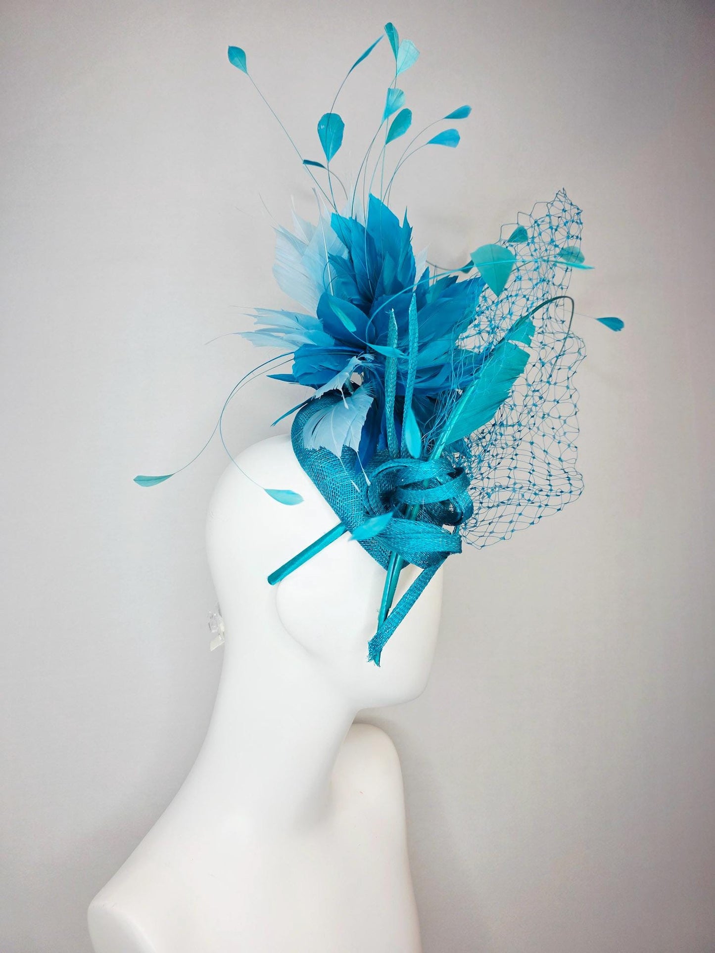 kentucky derby hat fascinator sky blue sinamay with sinamay bow and sky teal and light blue feathers and blue mesh veil