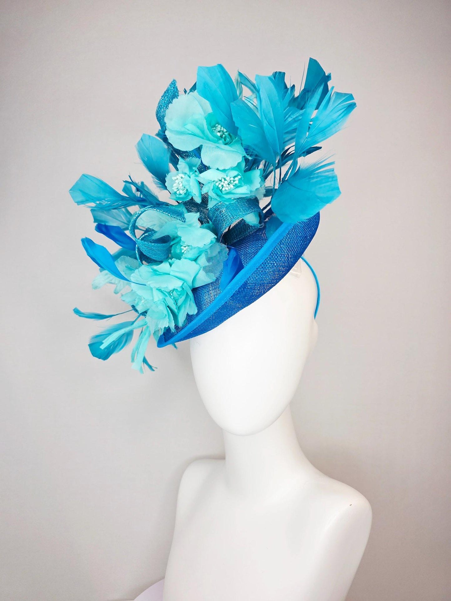 kentucky derby hat fascinator turquoise blue sinamay saucer with bow aqua blue organza satin flowers sky and royal blue branching feathers