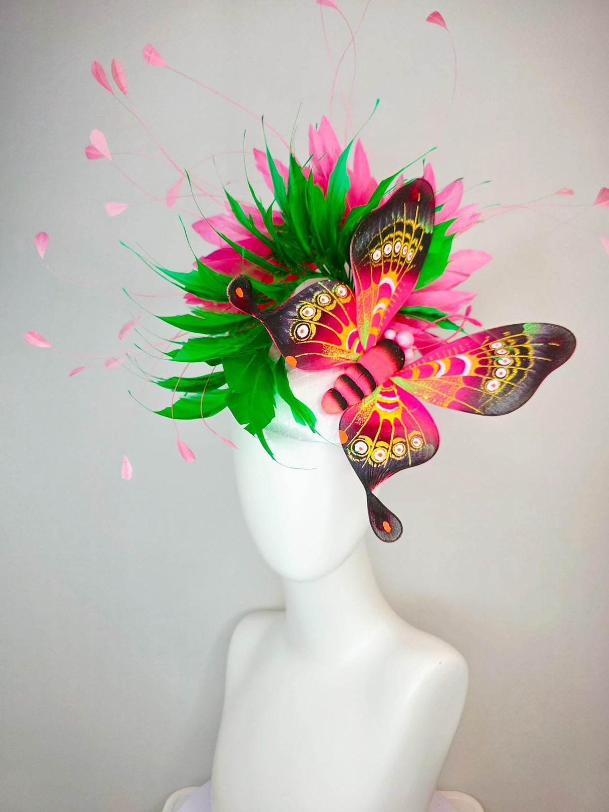 kentucky derby hat fascinator white satin with netting emerald green and hot pink branching feathers with large pink yellow black butterfly