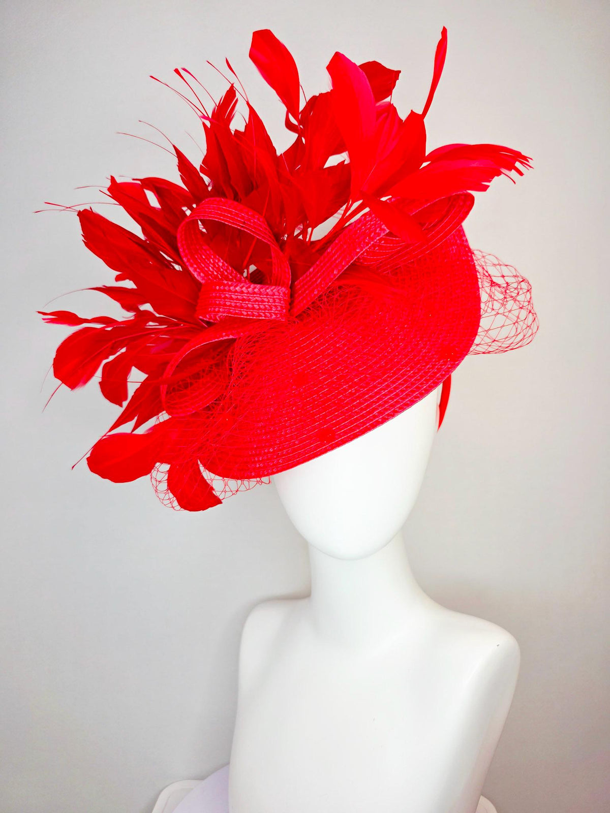 kentucky derby hat fascinator scarlet red straw saucer with red straw bow with bright red branching feathers and red mesh veil