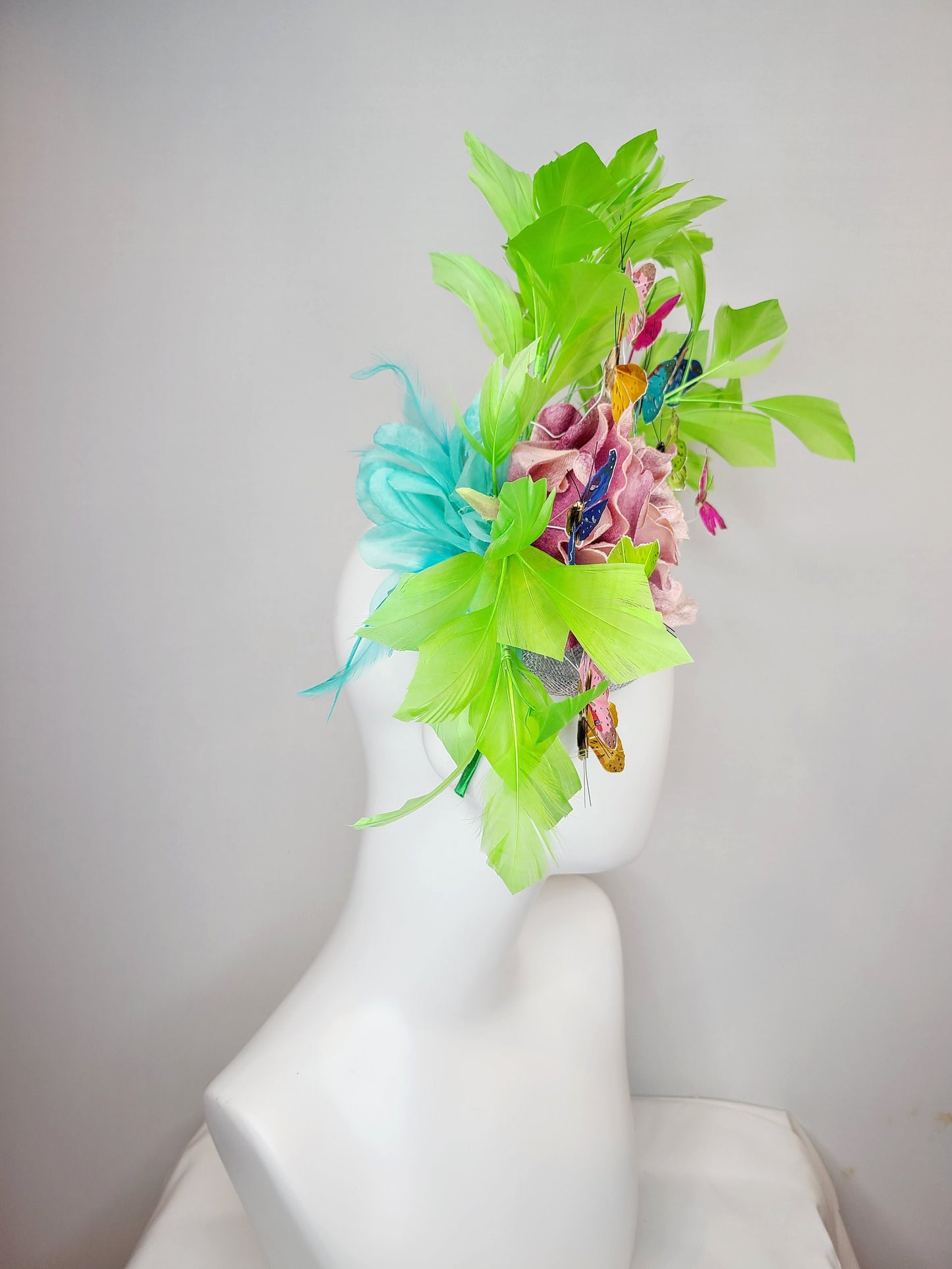 kentucky derby hat fascinator bright green feathers with mauve light pink rose rainbow pink yellow green blue decor and butterflies