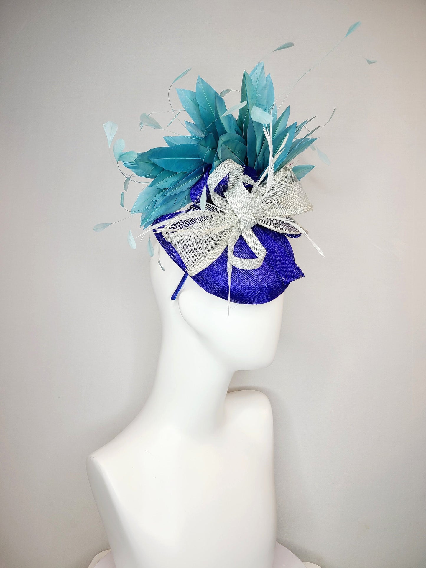 kentucky derby hat fascinator sinamay royal blue base with teal peacock blue  feathers with very light gray silver sinamay bow