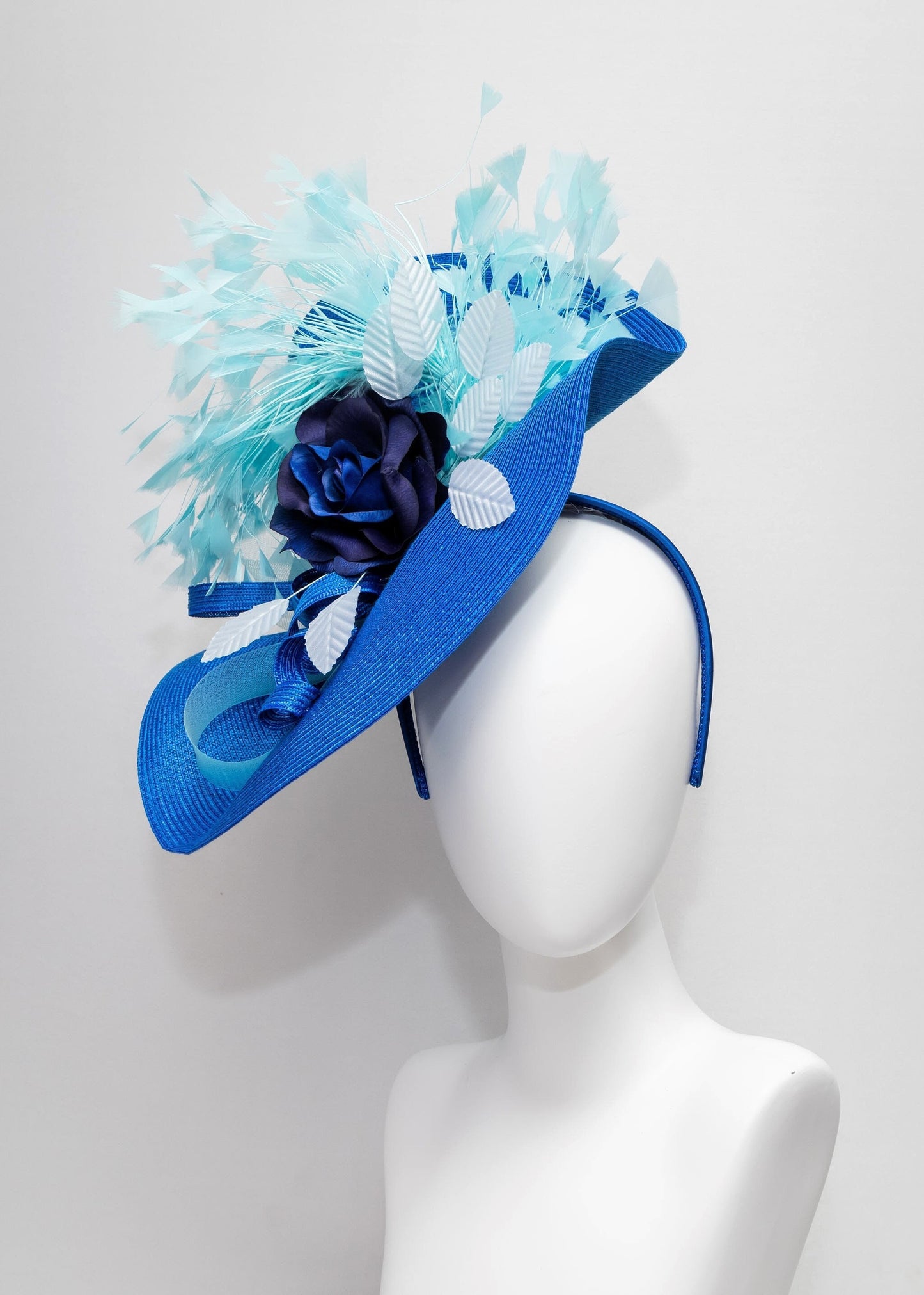 kentucky derby hat fascinator royal blue woven base with navy rose flower light blue leaves aqua turquoise  blue feathers