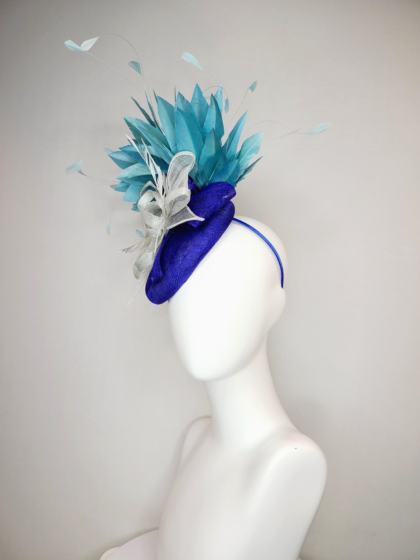 kentucky derby hat fascinator sinamay royal blue base with teal peacock blue  feathers with very light gray silver sinamay bow