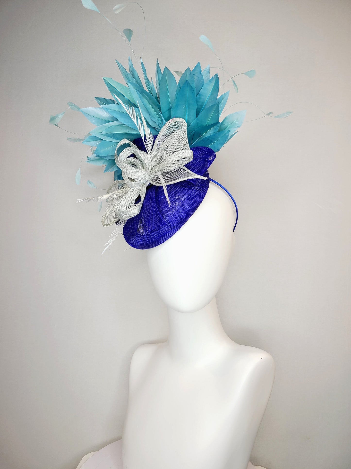 kentucky derby hat fascinator sinamay royal blue base with teal peacock blue  feathers with very light gray silver sinamay bow