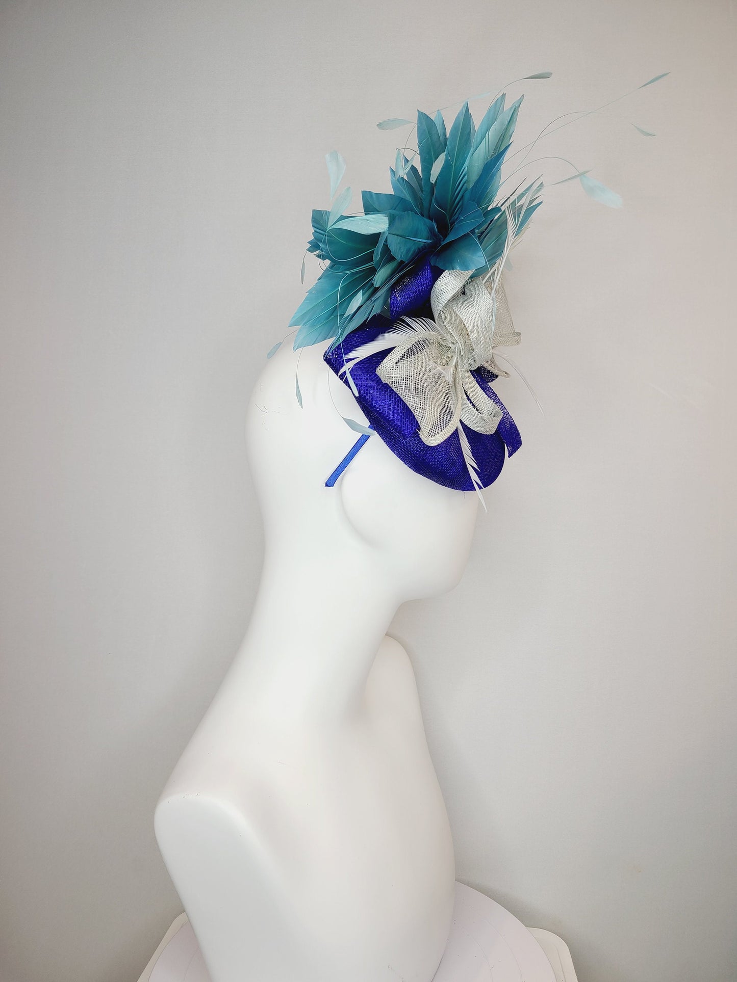 kentucky derby hat fascinator sinamay royal blue base with teal peacock blue  feathers with very light gray silver sinamay bow