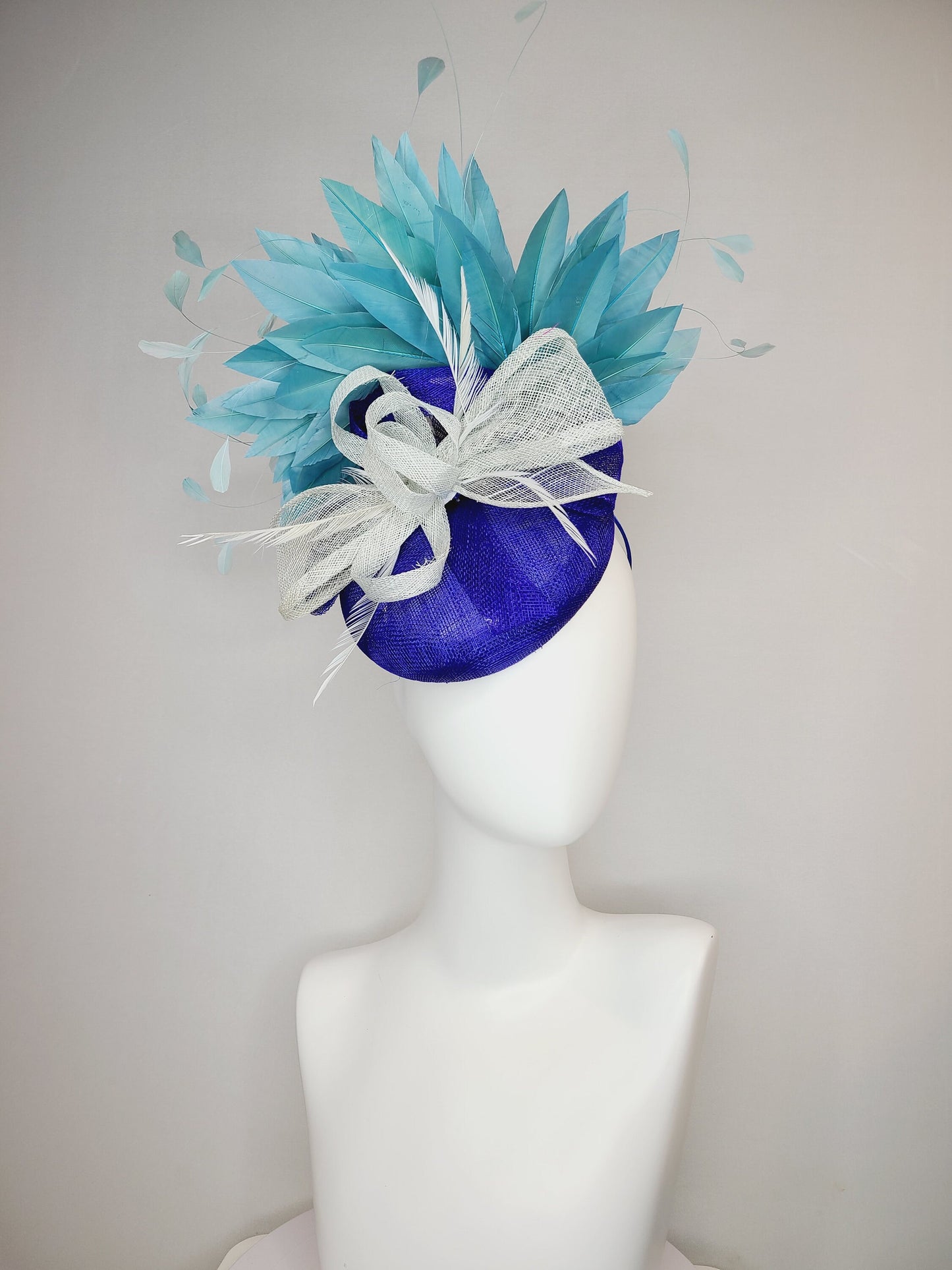 kentucky derby hat fascinator sinamay royal blue base with teal peacock blue  feathers with very light gray silver sinamay bow