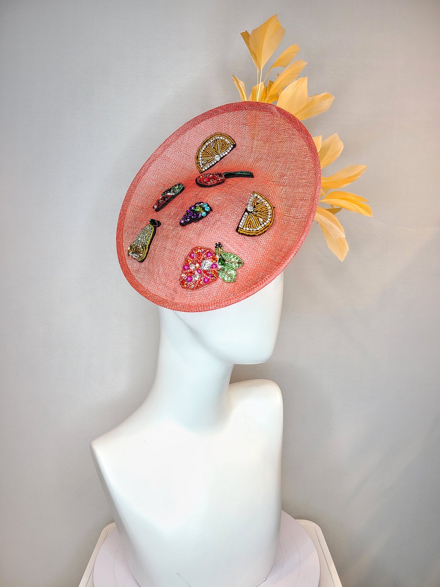 kentucky derby hat fascinator coral sinamay saucer with orange feathers with crystal rhinestone fruit grapes cherry lemon