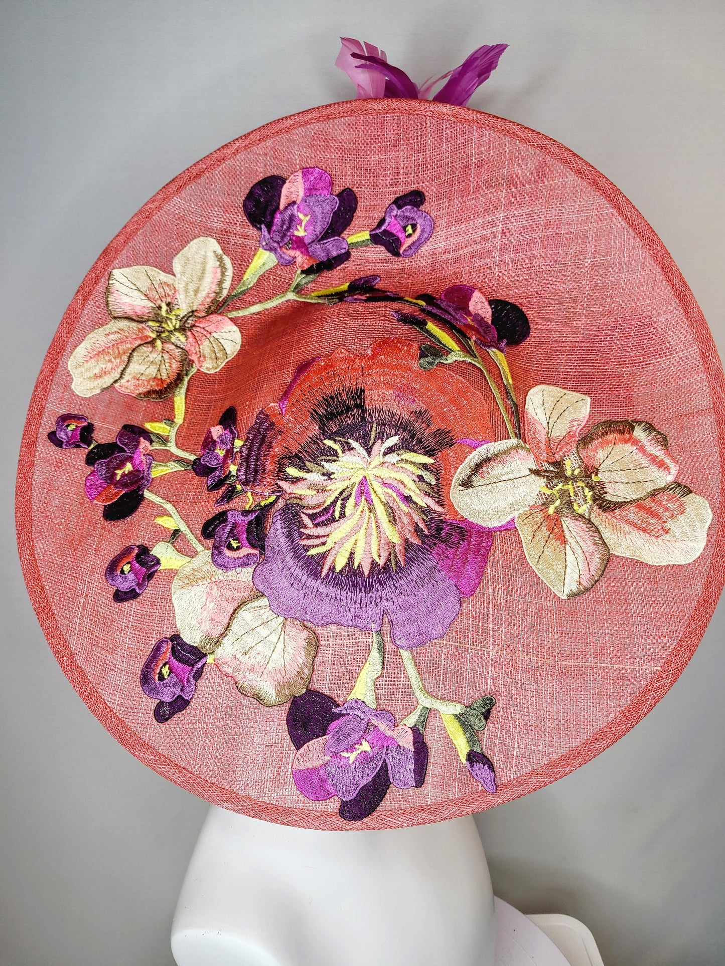 kentucky derby hat fascinator coral pink peach sinamay saucer fascinator with embroidered pink purple gold flowers with pink purple feathers
