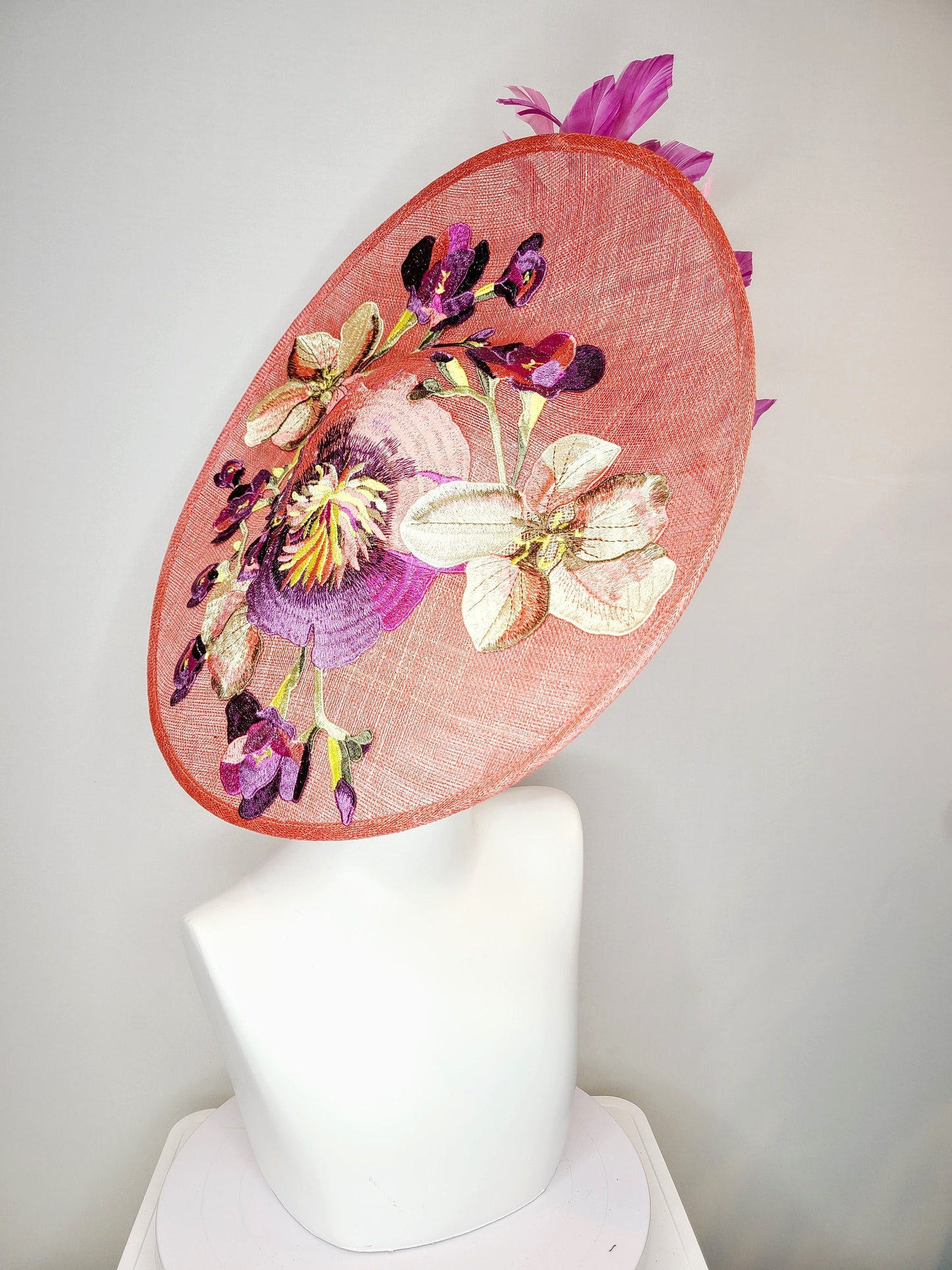 kentucky derby hat fascinator coral pink peach sinamay saucer fascinator with embroidered pink purple gold flowers with pink purple feathers