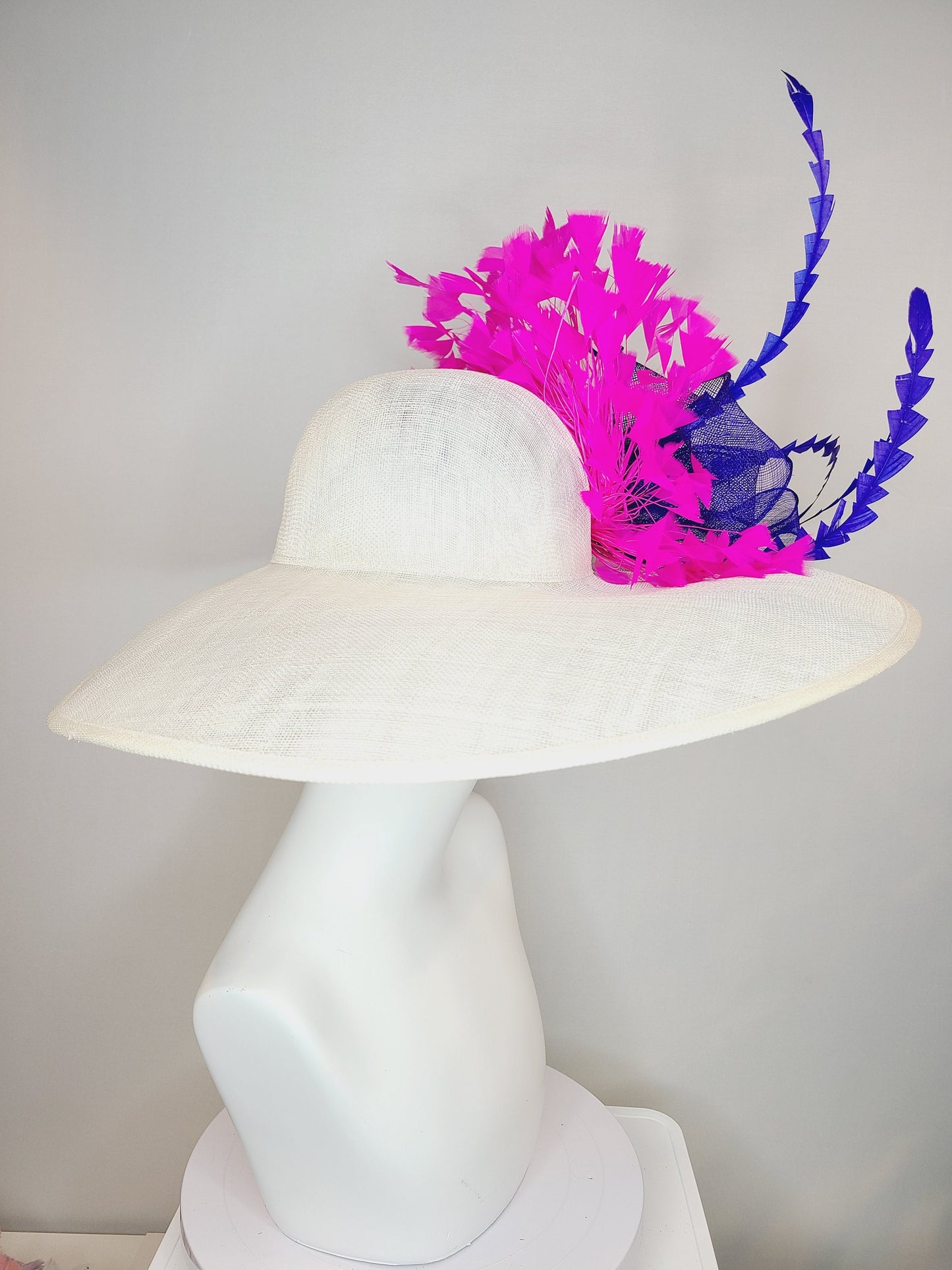 kentucky derby hat wide brim white sinamay with royal blue sinamay bow and hot pink fuchsia feathers