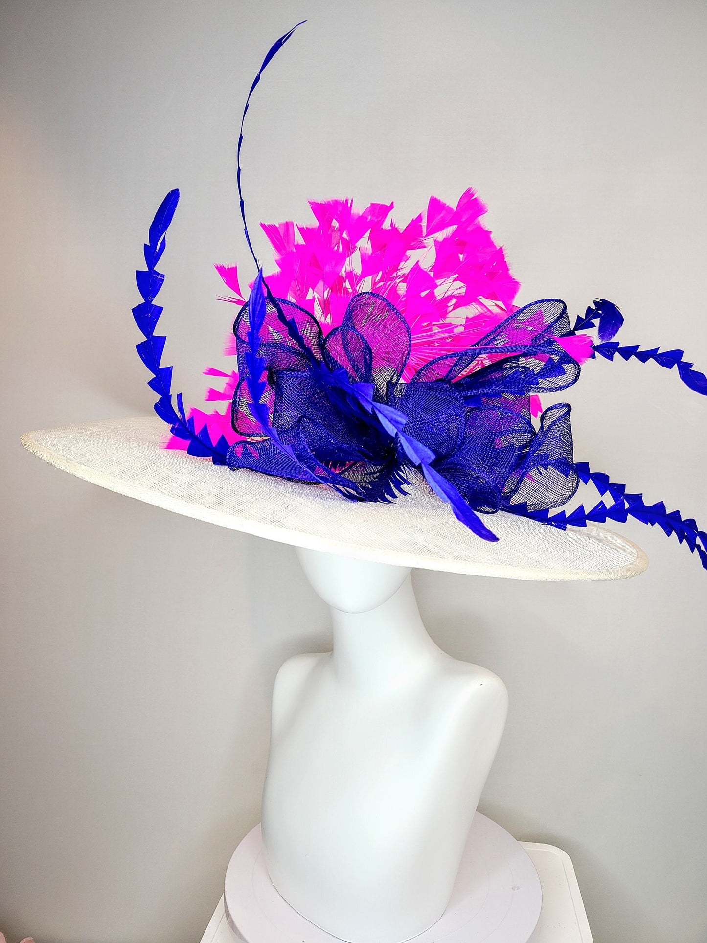 kentucky derby hat wide brim white sinamay with royal blue sinamay bow and hot pink fuchsia feathers