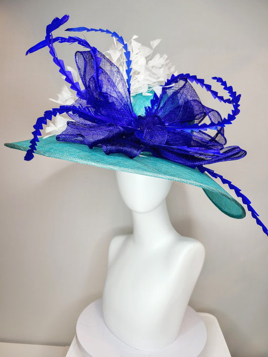 kentucky derby hat wide brim sinamay in teal blue green with large royal blue sinamay bow and  white   feathers