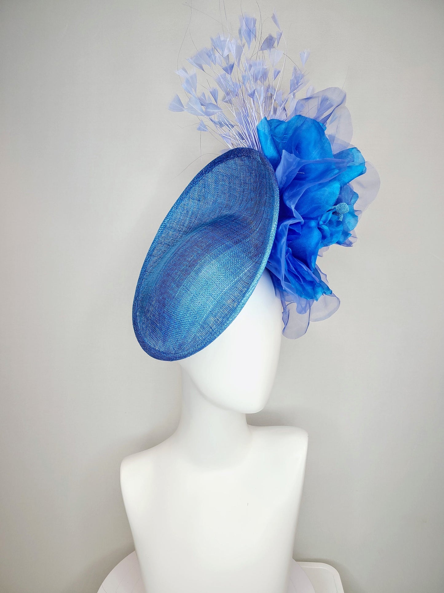 kentucky derby hat fascinator blue sinamay with royal blue large organza flower with periwinkle blue triangle feather spray