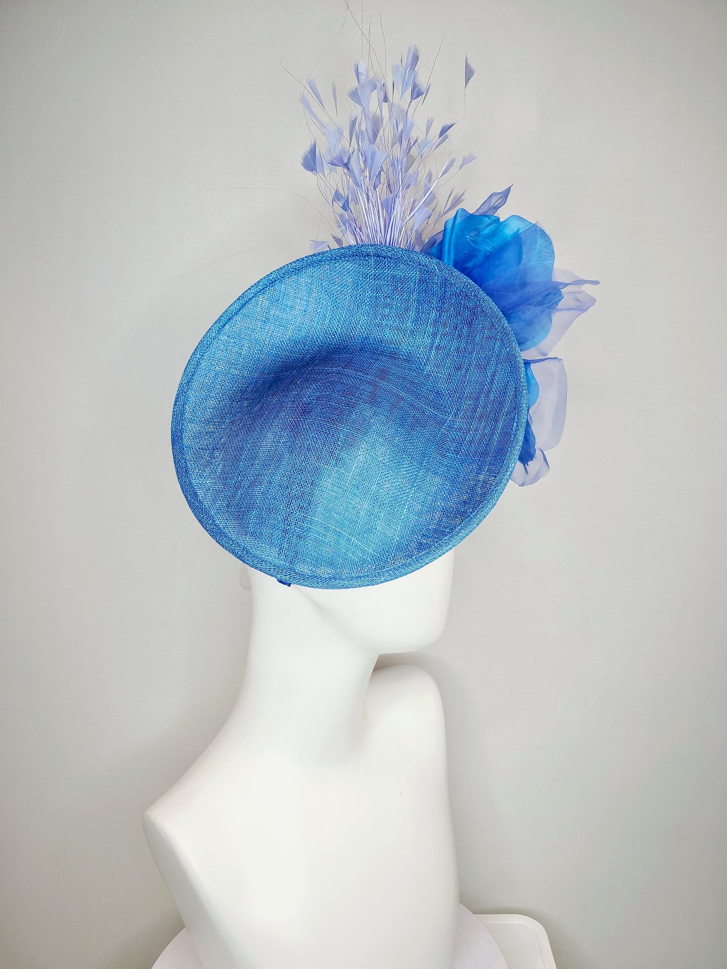 kentucky derby hat fascinator blue sinamay with royal blue large organza flower with periwinkle blue triangle feather spray