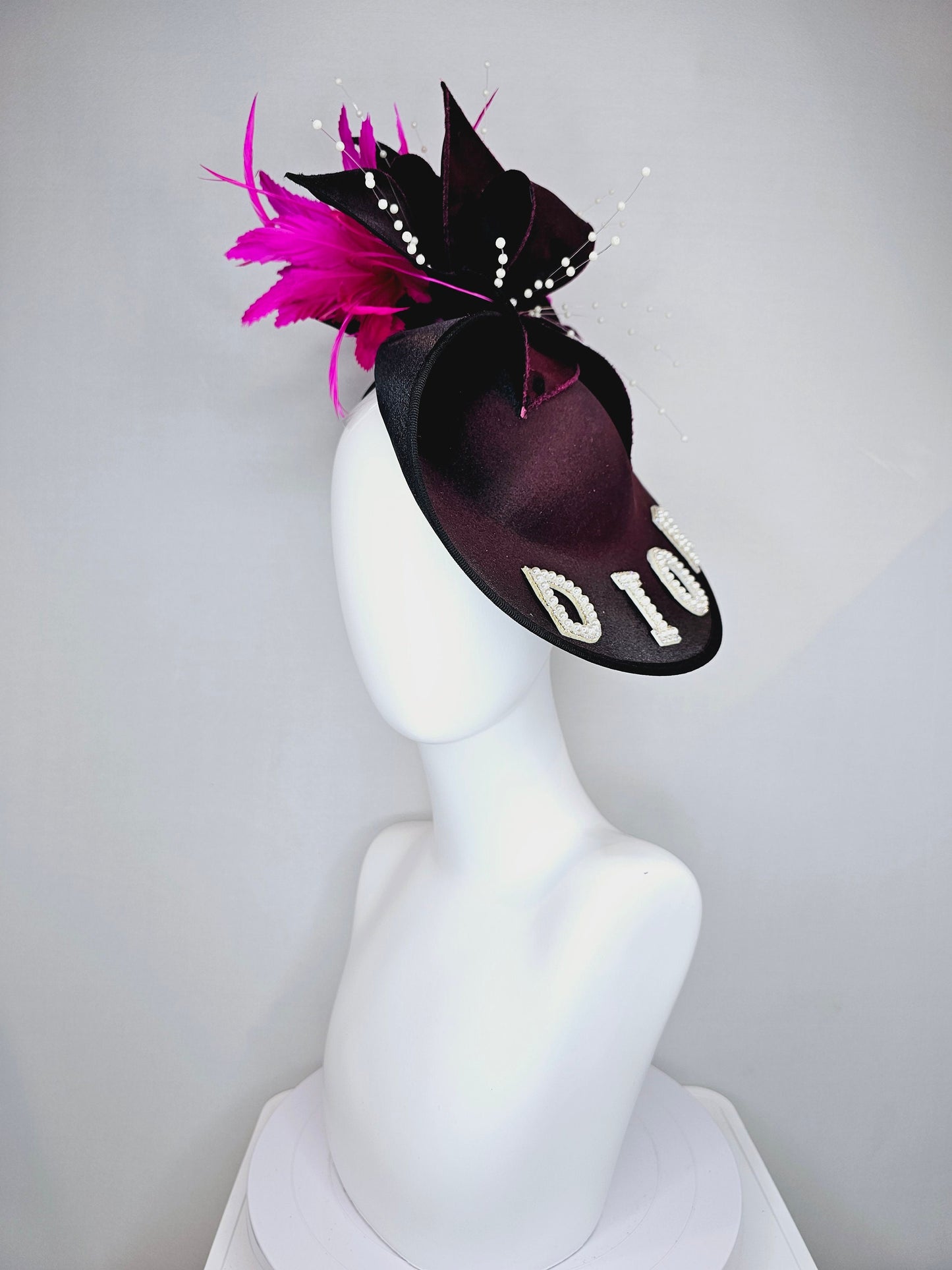 kentucky derby hat fascinator black satin saucer with airbrush pink and white letter decor pink feathers white pearls