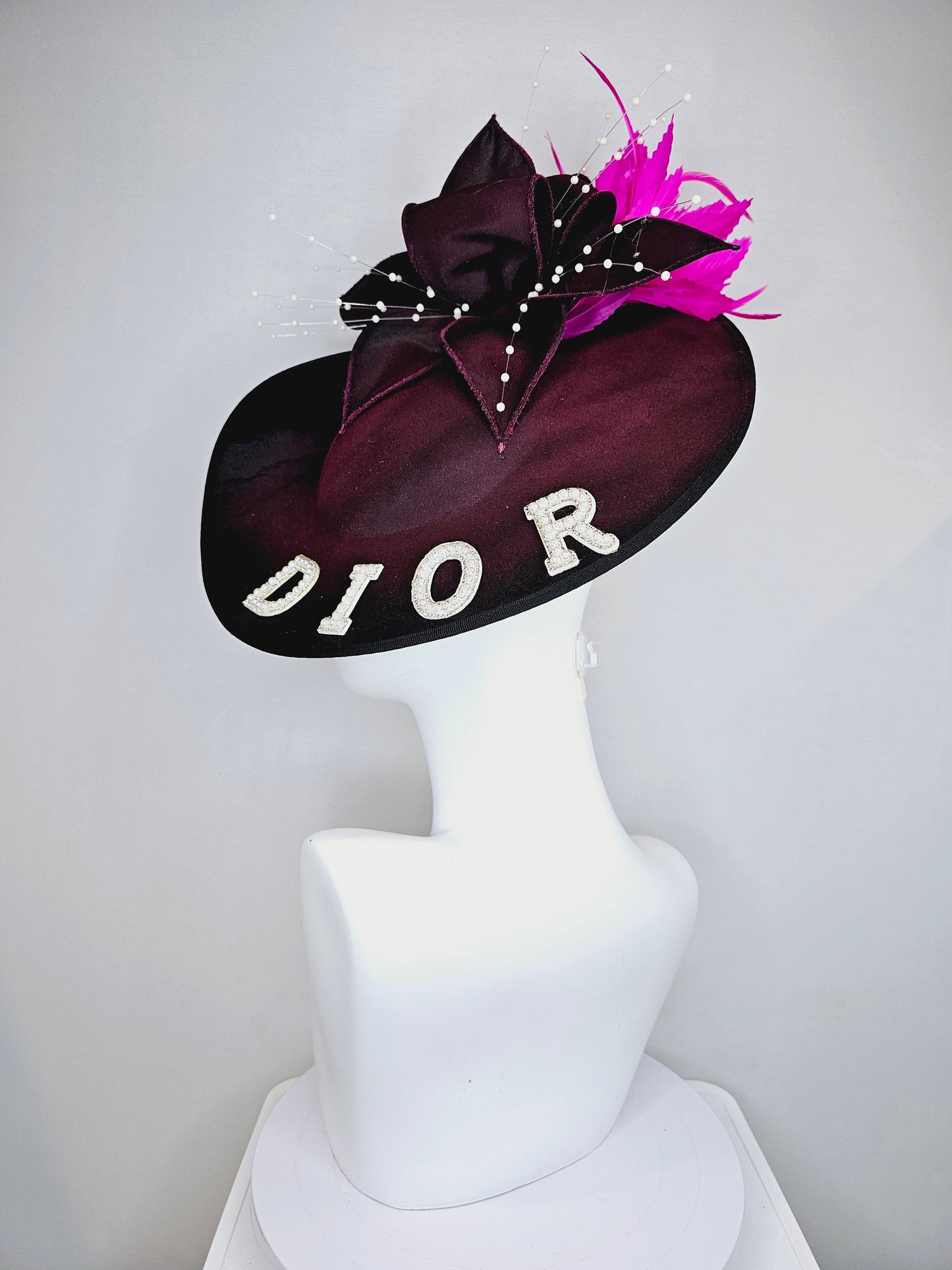 kentucky derby hat fascinator black satin saucer with airbrush pink and white letter decor pink feathers white pearls