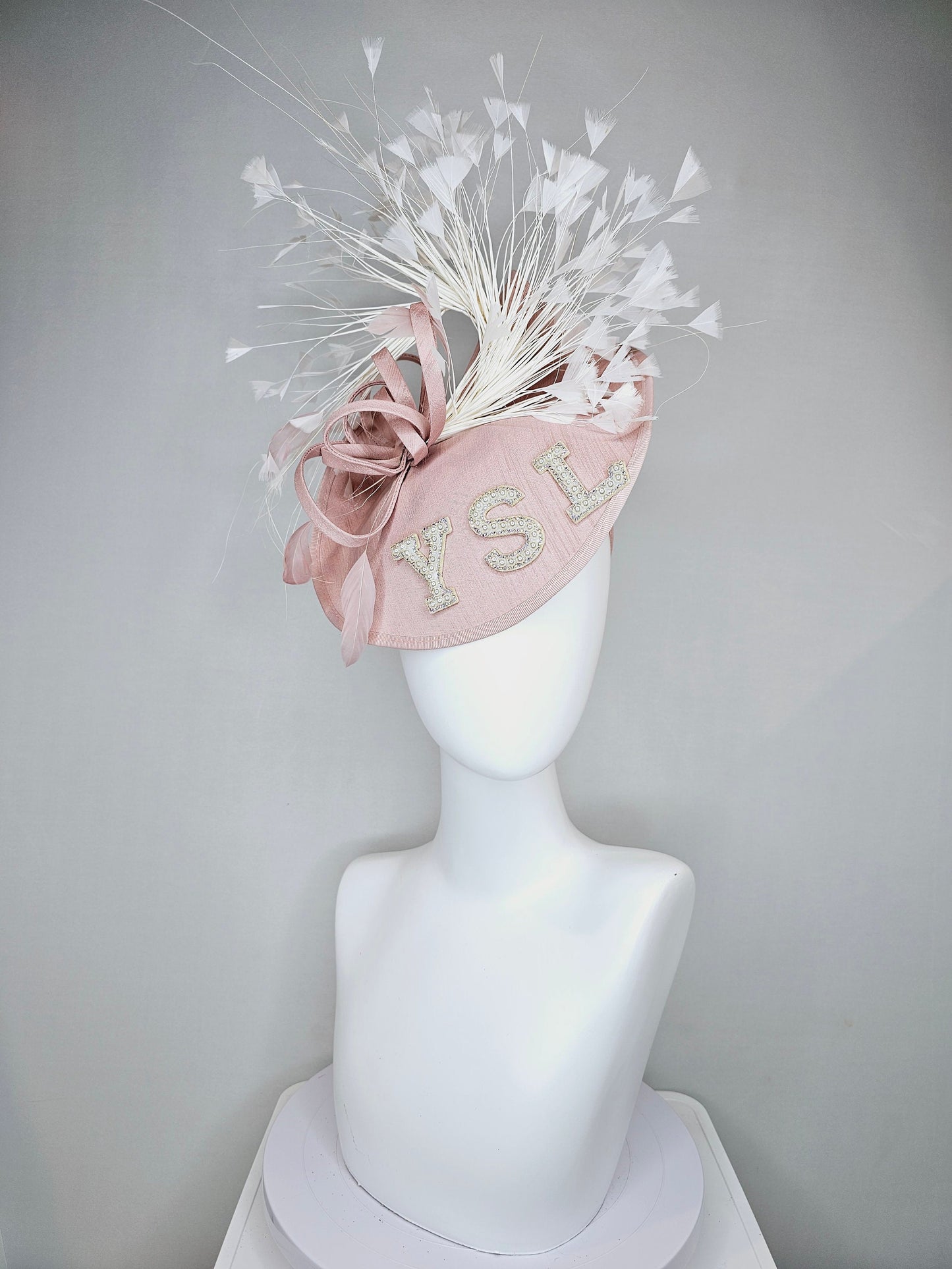 kentucky derby hat fascinator dusty rose blush silk like saucer with white feathers and beaded pearl letters