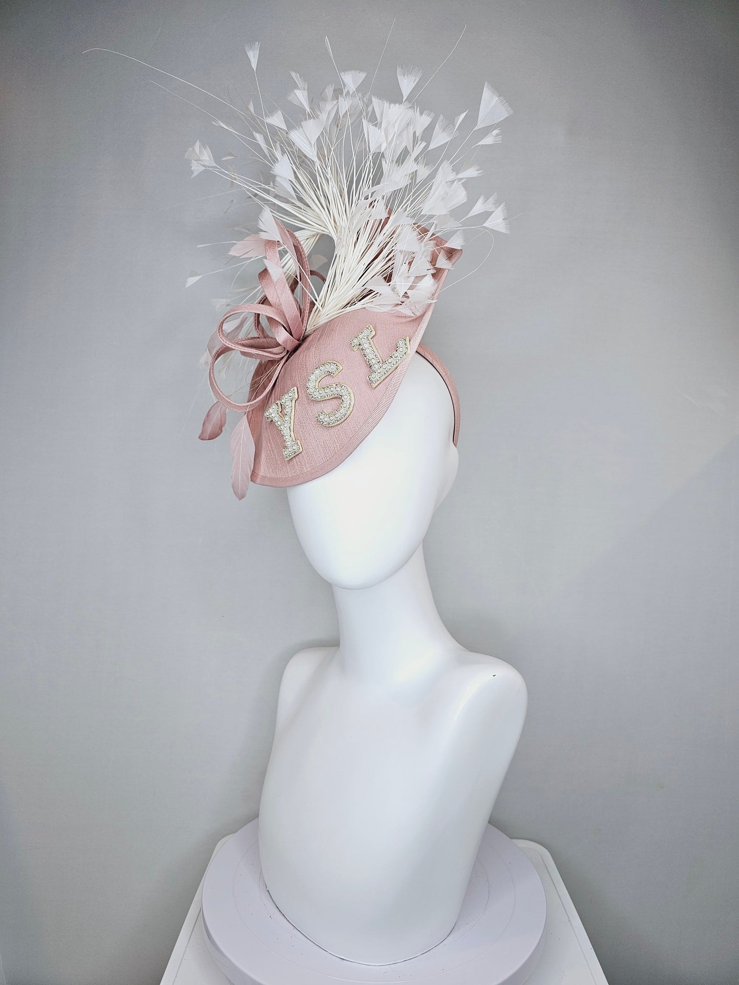 kentucky derby hat fascinator dusty rose blush silk like saucer with white feathers and beaded pearl letters