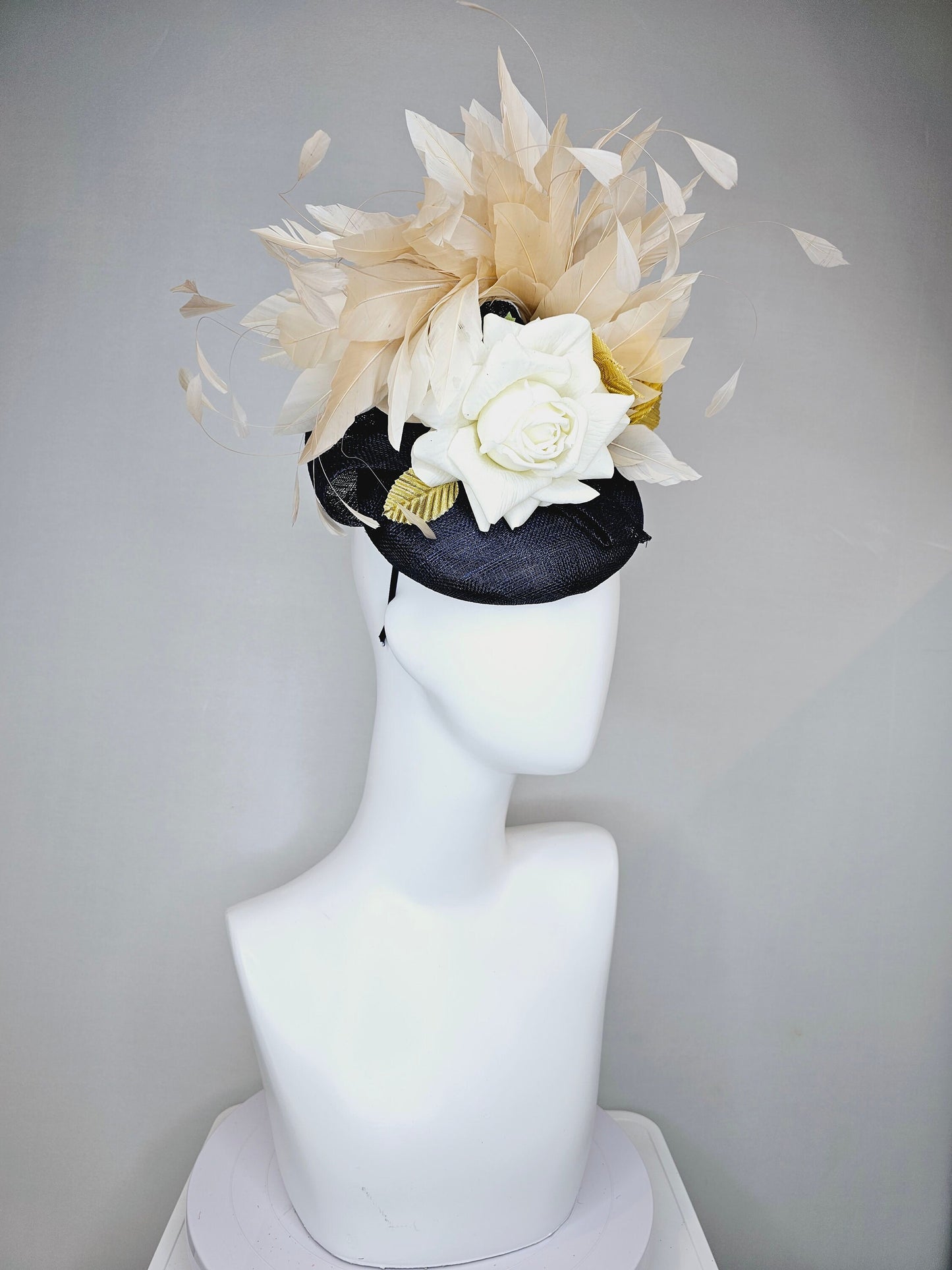 kentucky derby hat fascinator navy sinamay base with white rose and beige light gold peach feathers with bright gold lame leaves