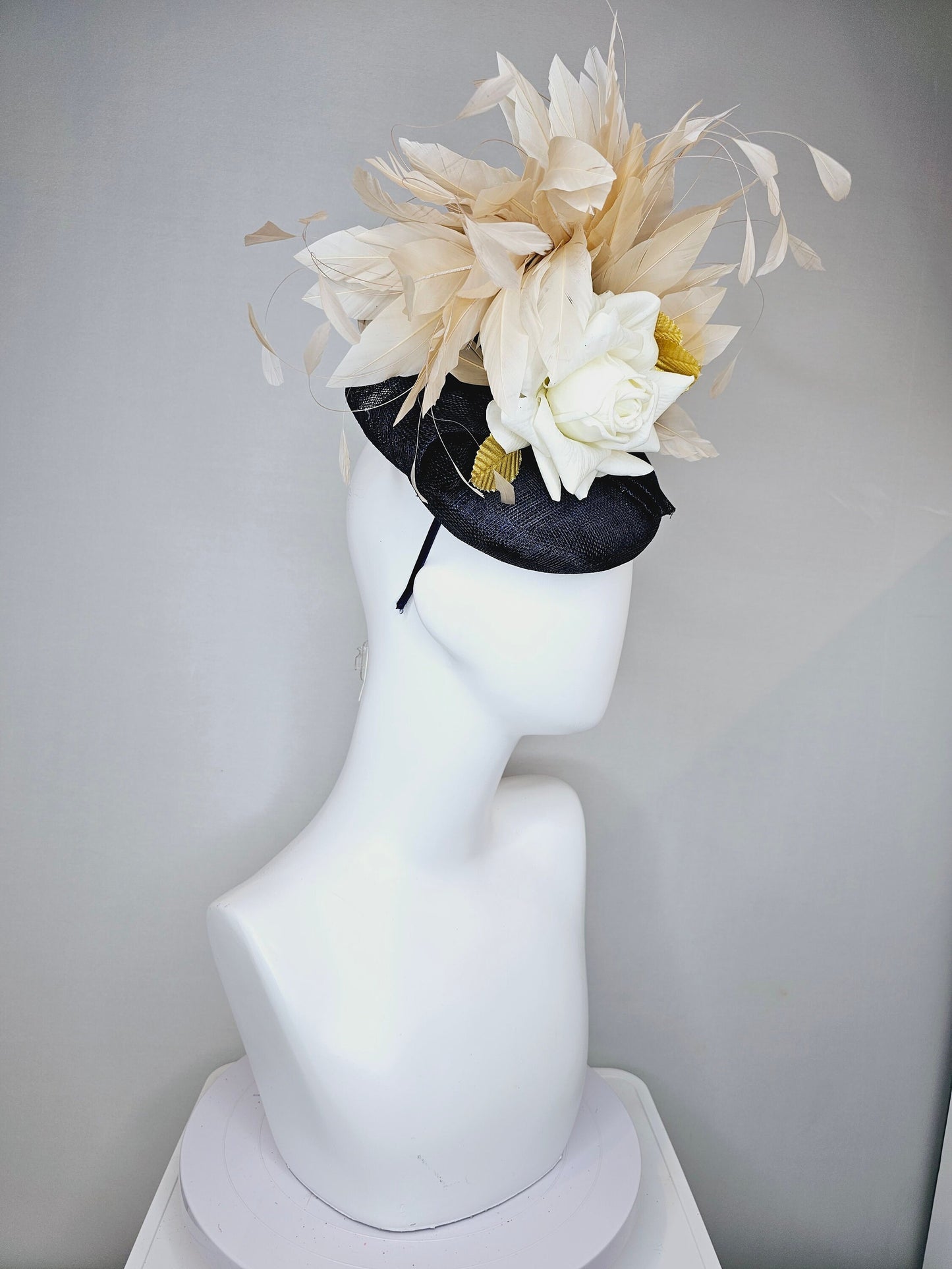 kentucky derby hat fascinator navy sinamay base with white rose and beige light gold peach feathers with bright gold lame leaves